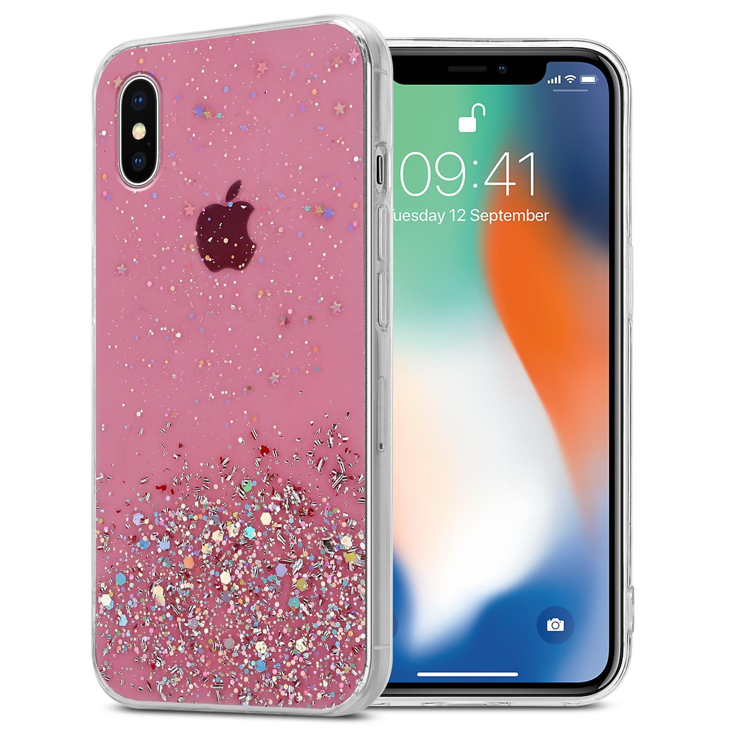Rosa glitzernde Handyhülle und Handy. Die Hülle hat Glitzer mit Sternen. Das Telefon zeigt Datum und Uhrzeit.