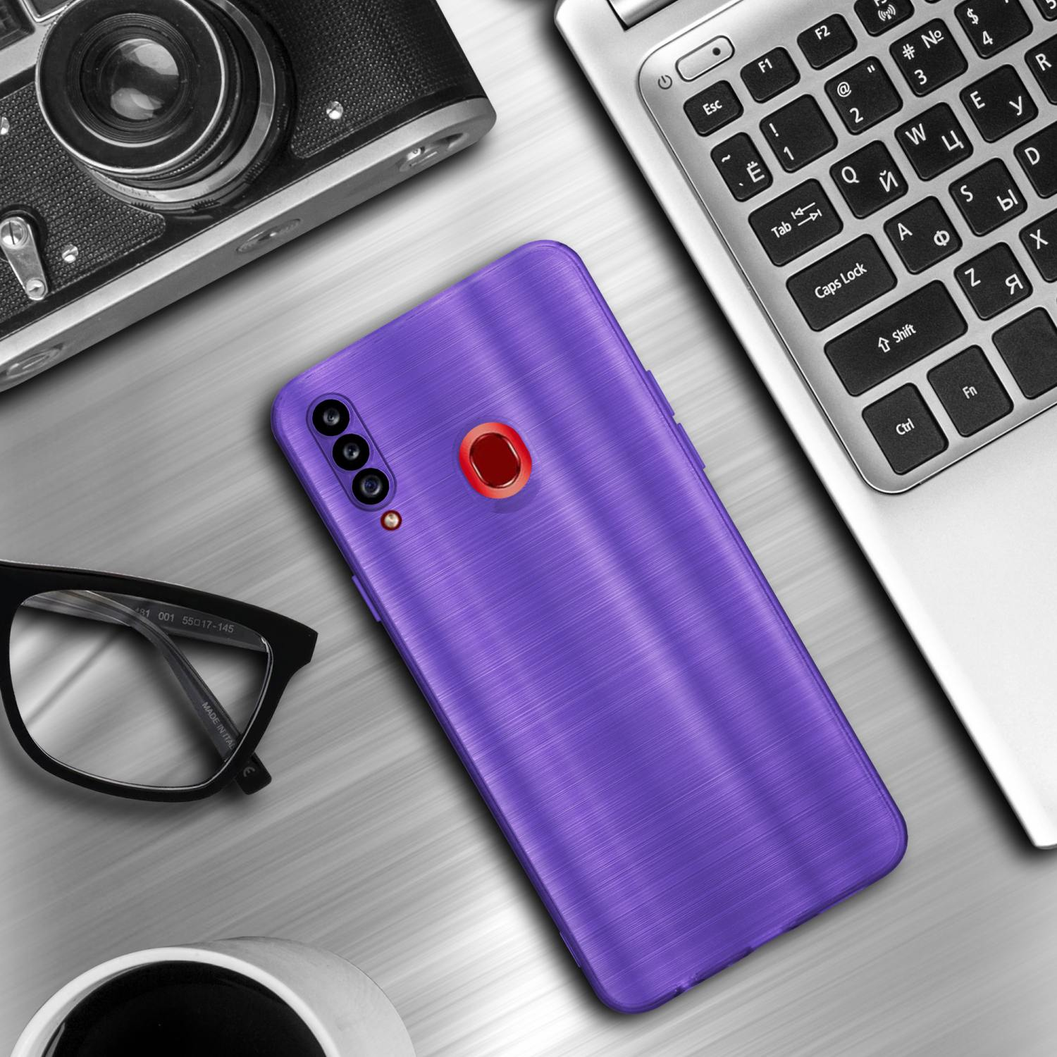 Una custodia per telefono viola, un laptop, una fotocamera e occhiali su un tavolo. Una tazza da caffè bianca.
