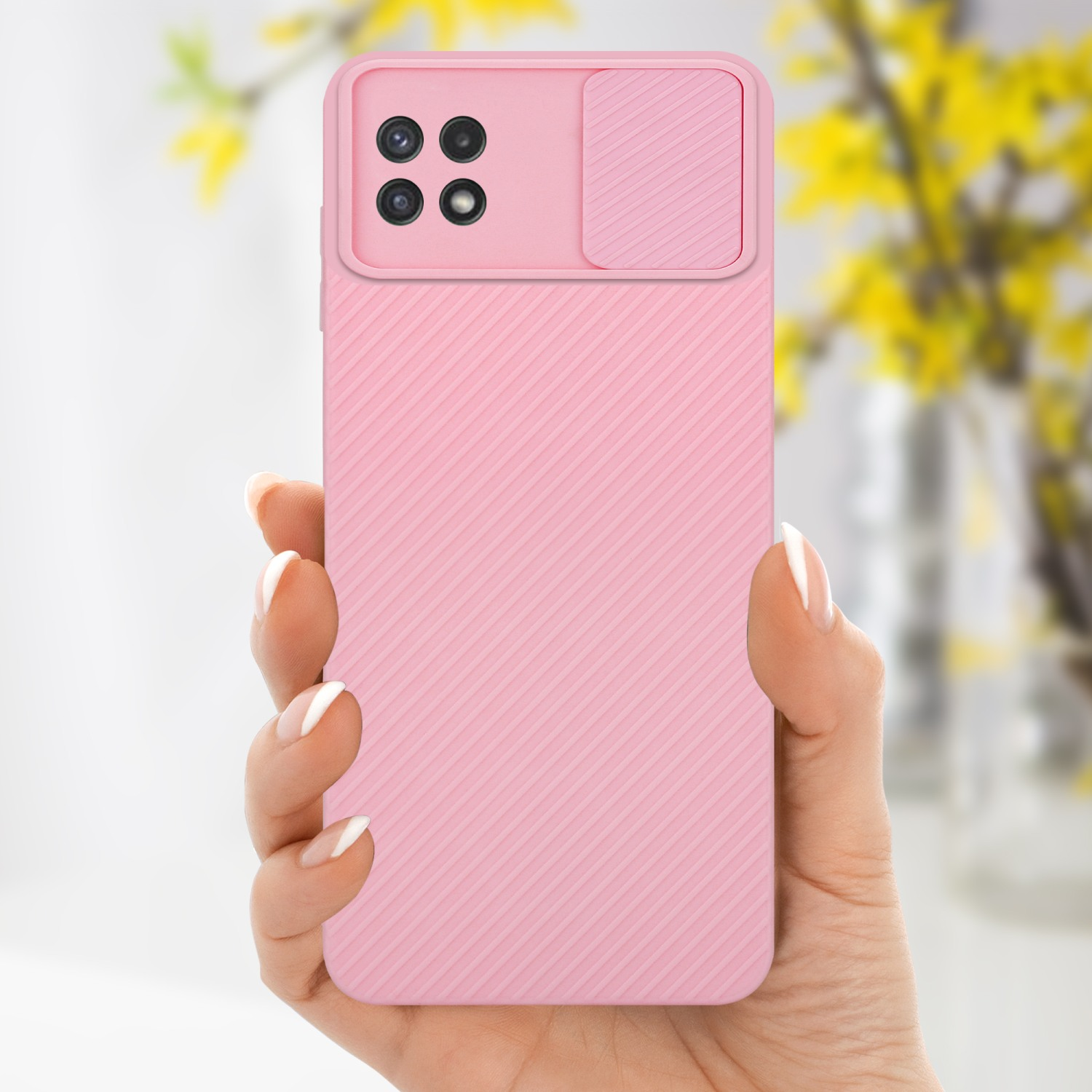 Eine Hand hält eine rosa Handyhülle. Die Hülle hat ein strukturiertes Design und eine Kameraabdeckung.