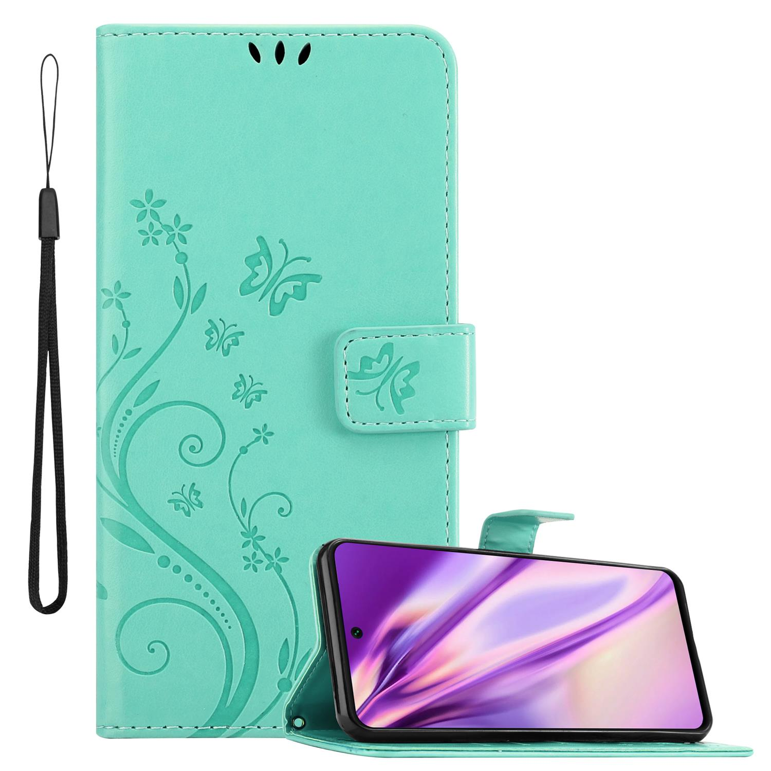 Eine türkisgrüne Handyhülle, geöffnet, mit einem Telefon. Die Hülle hat ein Blumendesign und eine Handschlaufe.