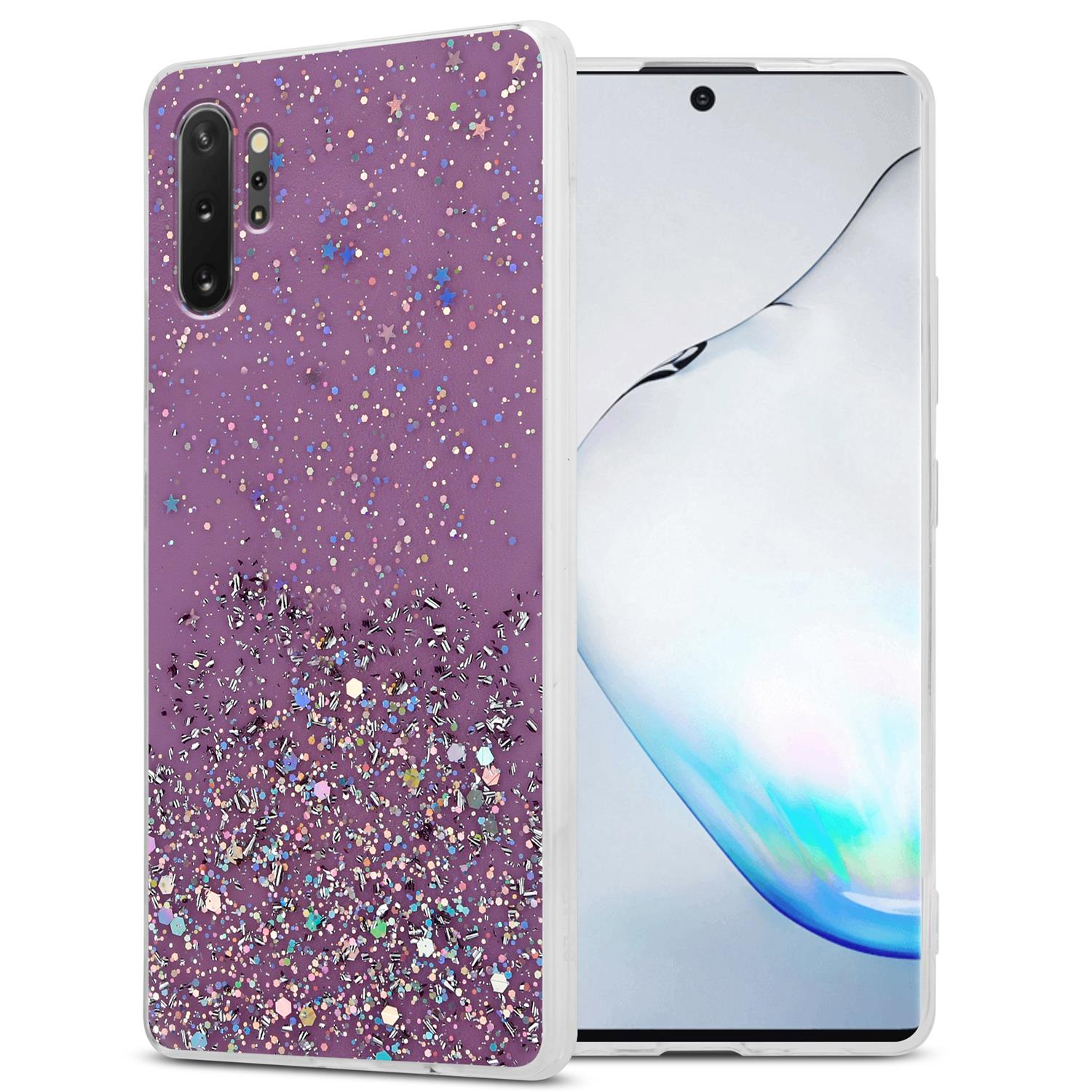 Lila Handyhülle mit Glitzer und Sternen. Telefon zeigt Uhrzeit und schwarze Oberfläche.