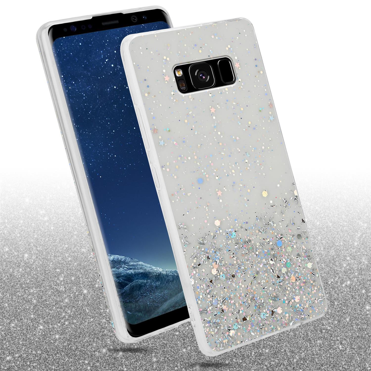 Weiße Handyhülle mit Glitzer und Sternen. Telefon ist schwarz. Der Hintergrund ist glitzernd.