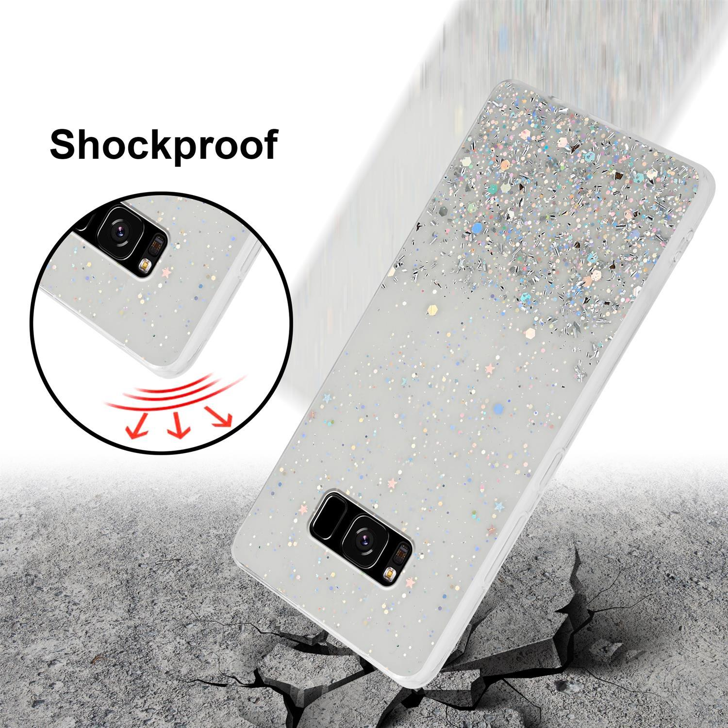 Weiße Handyhülle mit Glitzer, Aufprallrisse im Hintergrund. Die Hülle ist stoßfest.