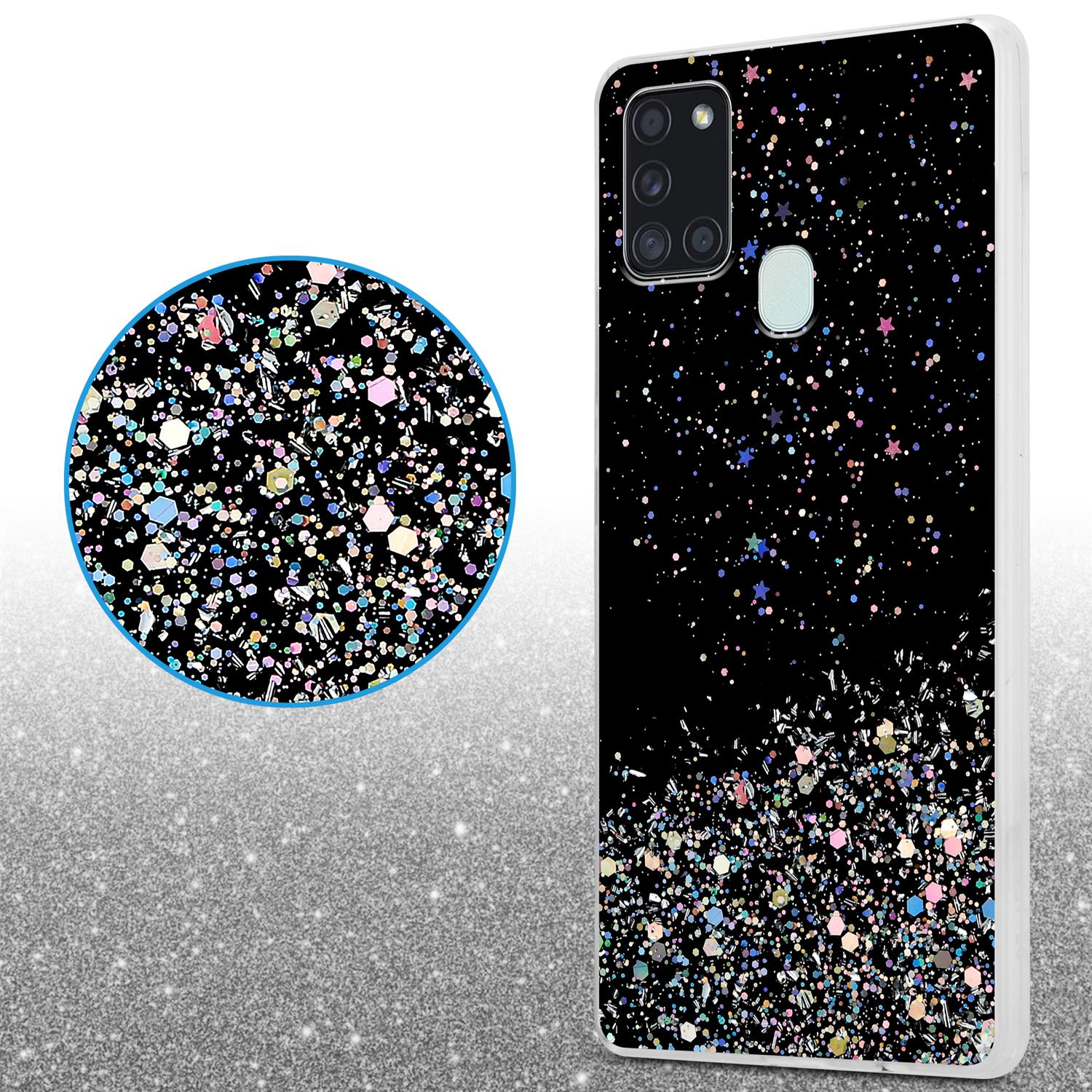 Custodia per telefono con sfondo nero, ricoperta di glitter. Lente d'ingrandimento mostra i glitter.