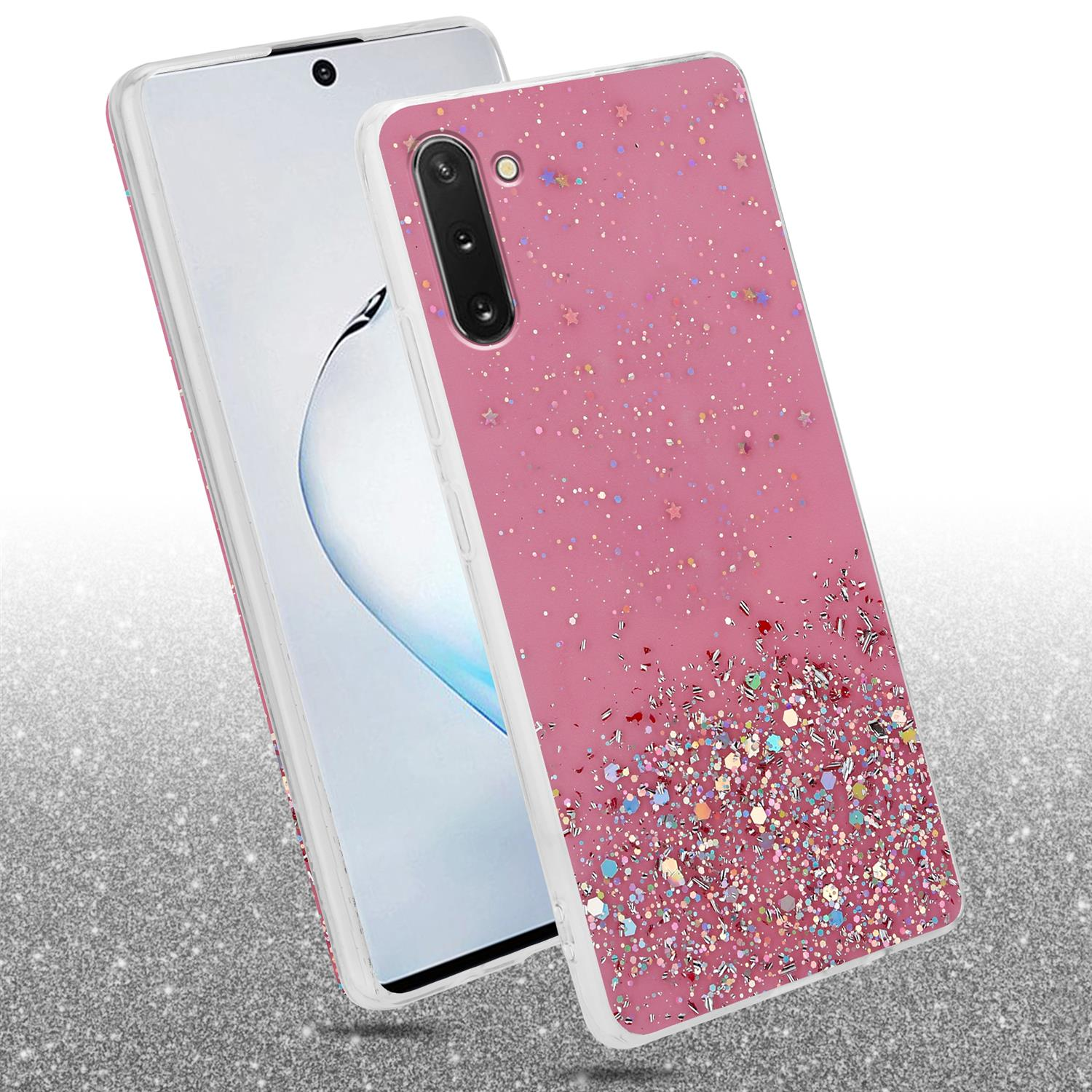 Custodia per telefono rosa con design glitterato, appoggiata a un telefono. Lo sfondo è una superficie glitterata.