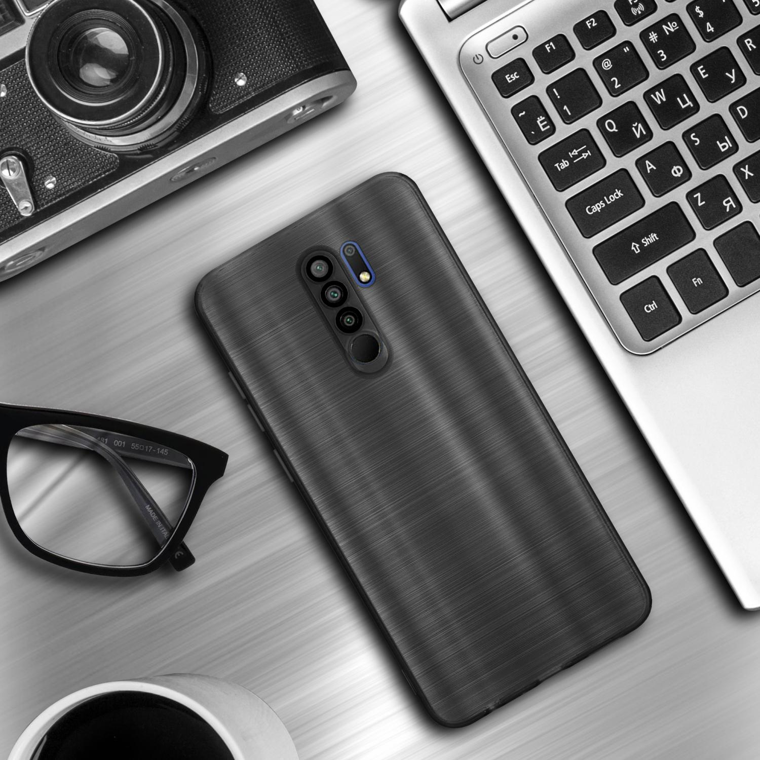 Custodia nera per telefono su un tavolo con occhiali, un laptop e una tazza di caffè.