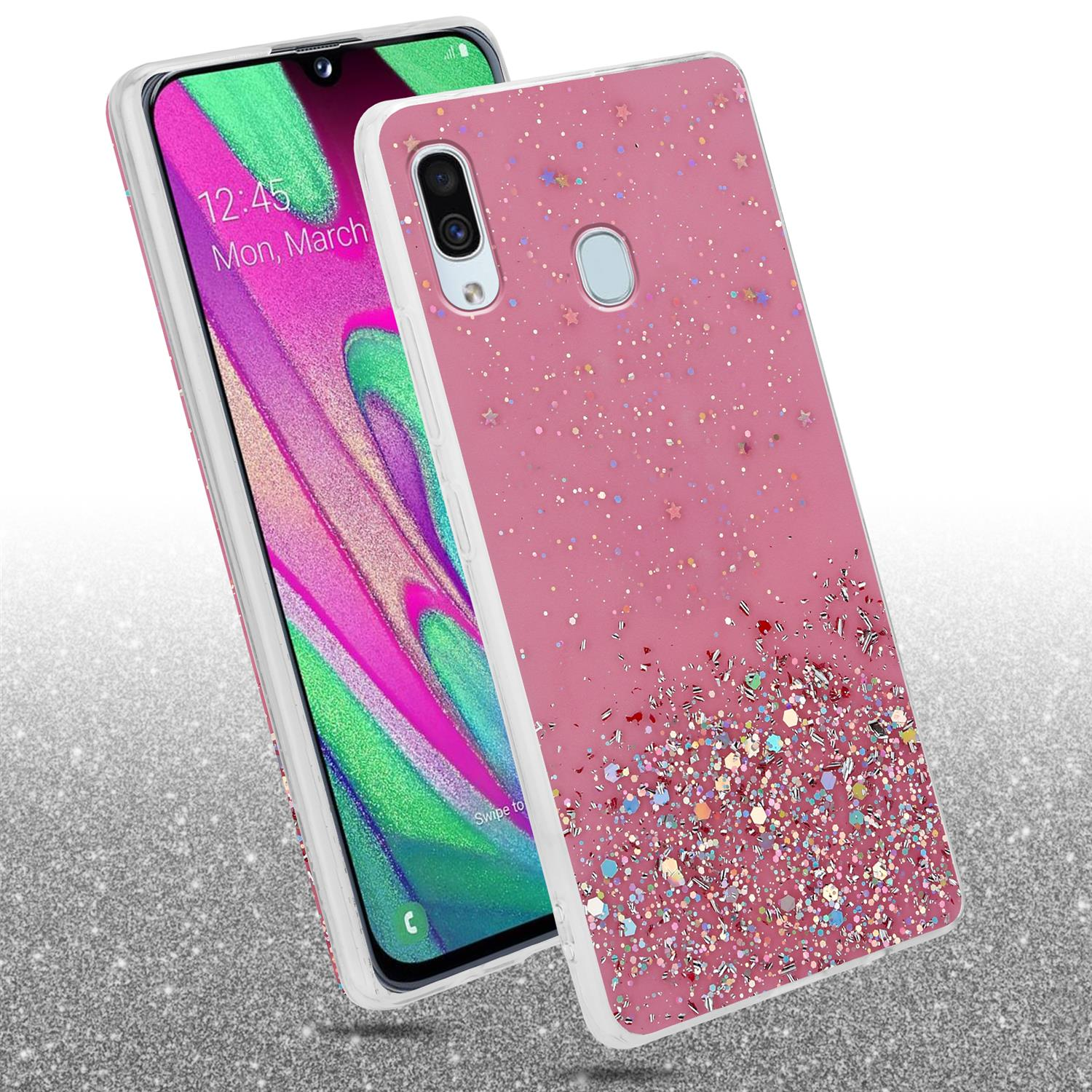Telefon in rosa Hülle mit Glitzer und Sternen. Ein zweites Telefon zeigt das Display: Mon, 4. März.