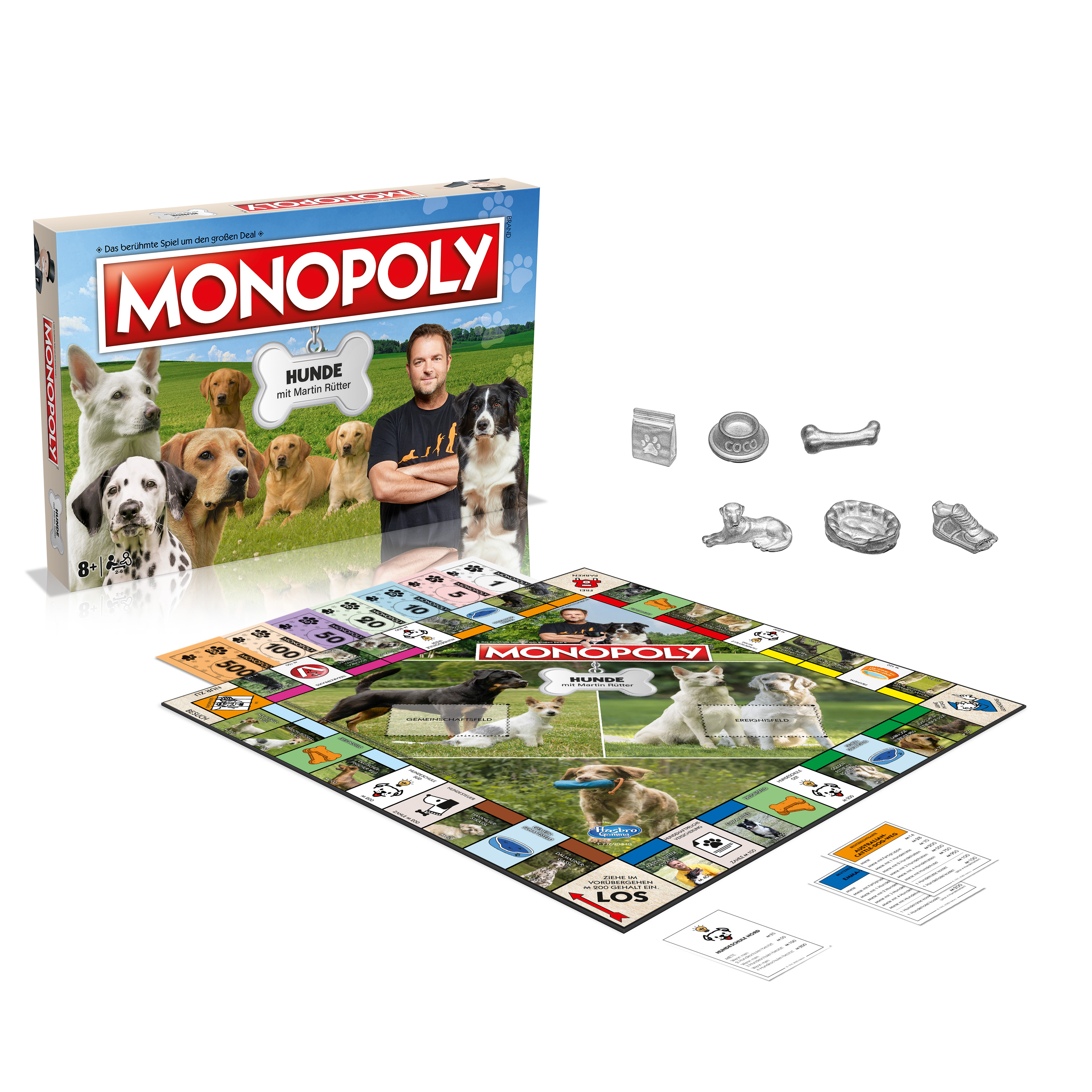 Monopoly-Brettspielbox und -Elemente. Die Box zeigt einen Mann mit Hunden.