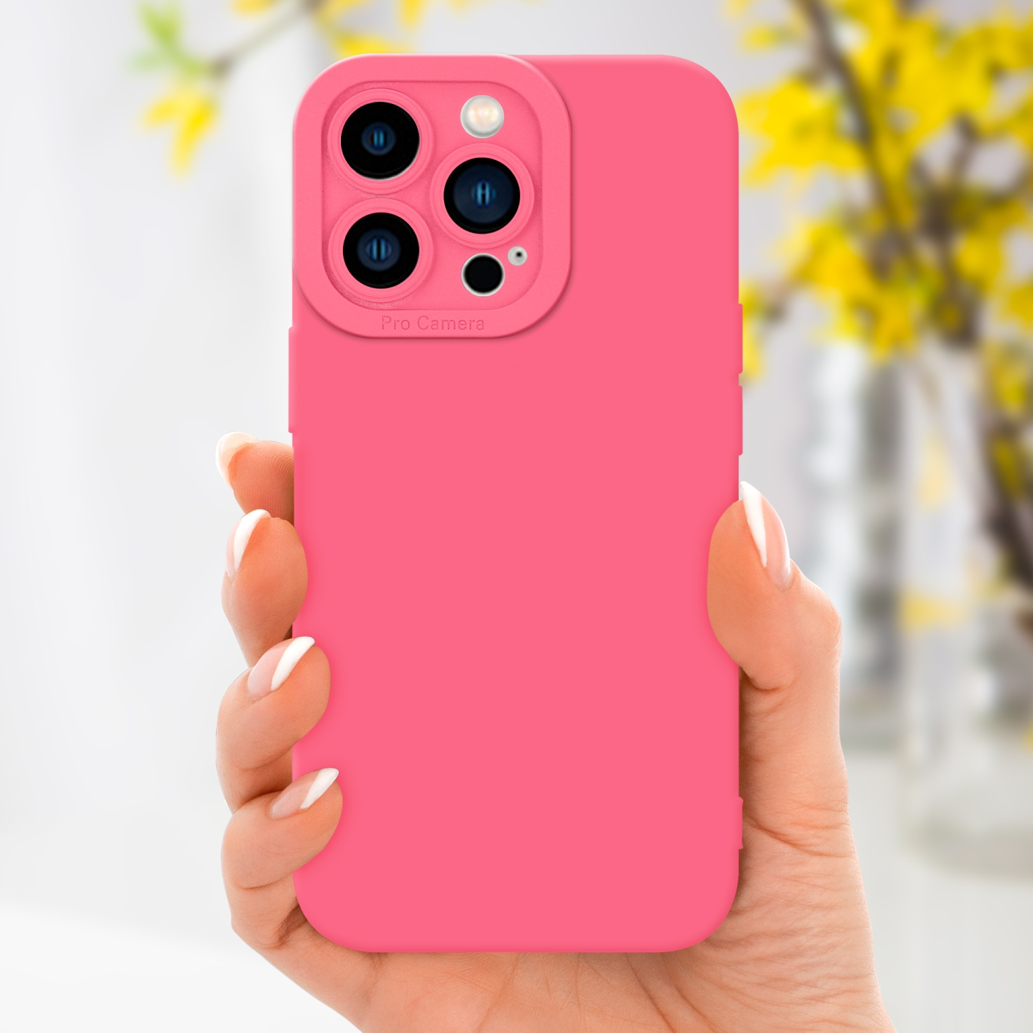 Eine rosa Handyhülle, gehalten von einer Hand, mit Kamera-Bump. Verschwommene gelbe Blumen im Hintergrund.