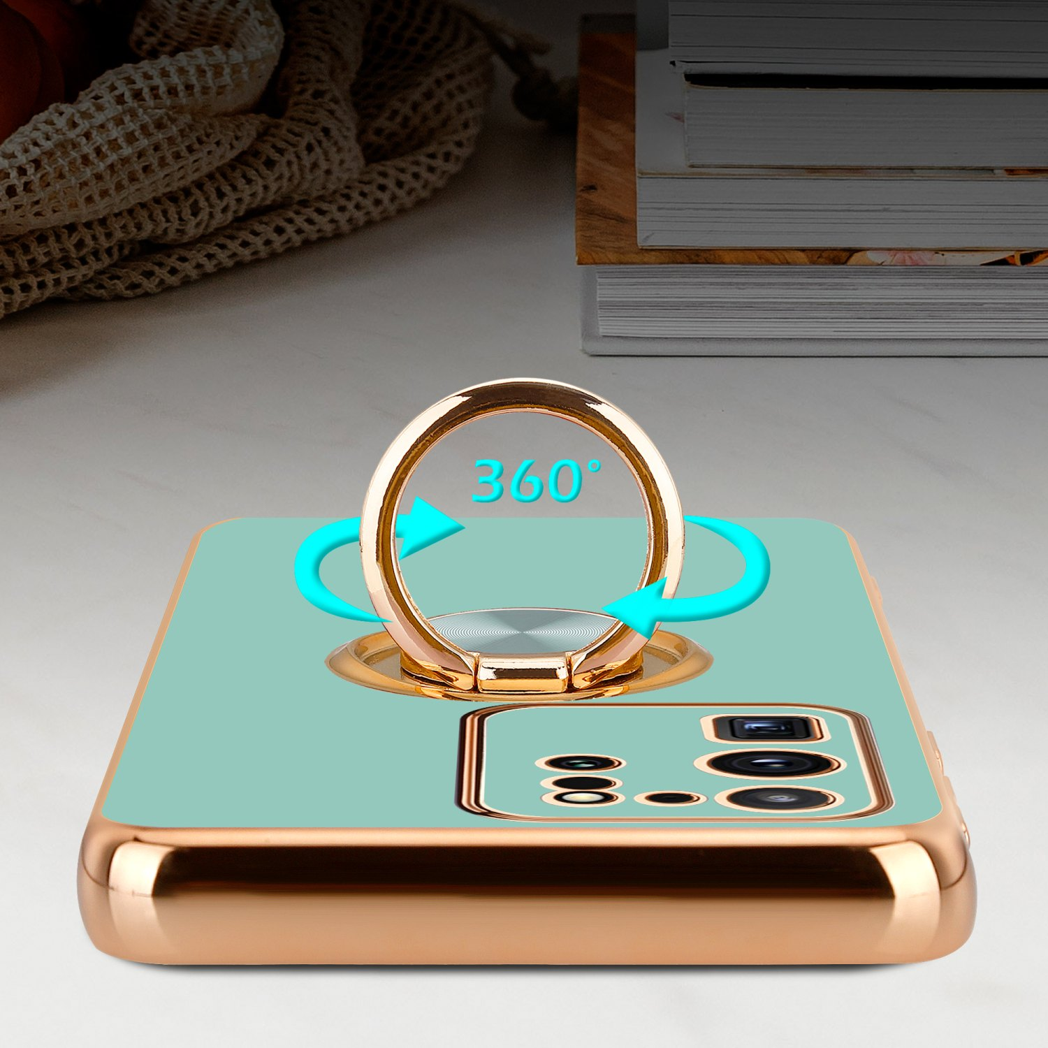 Telefono in una custodia dorata con un supporto ad anello rotante a 360 gradi.