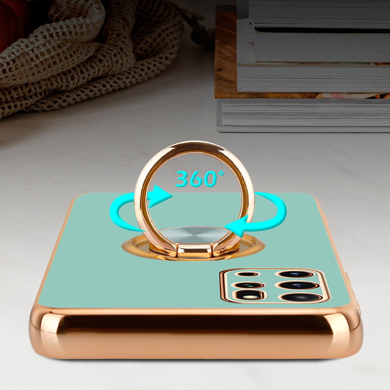 Telefon mit Ringhalterung. Der Ring ist goldfarben und die Handyhülle türkis.