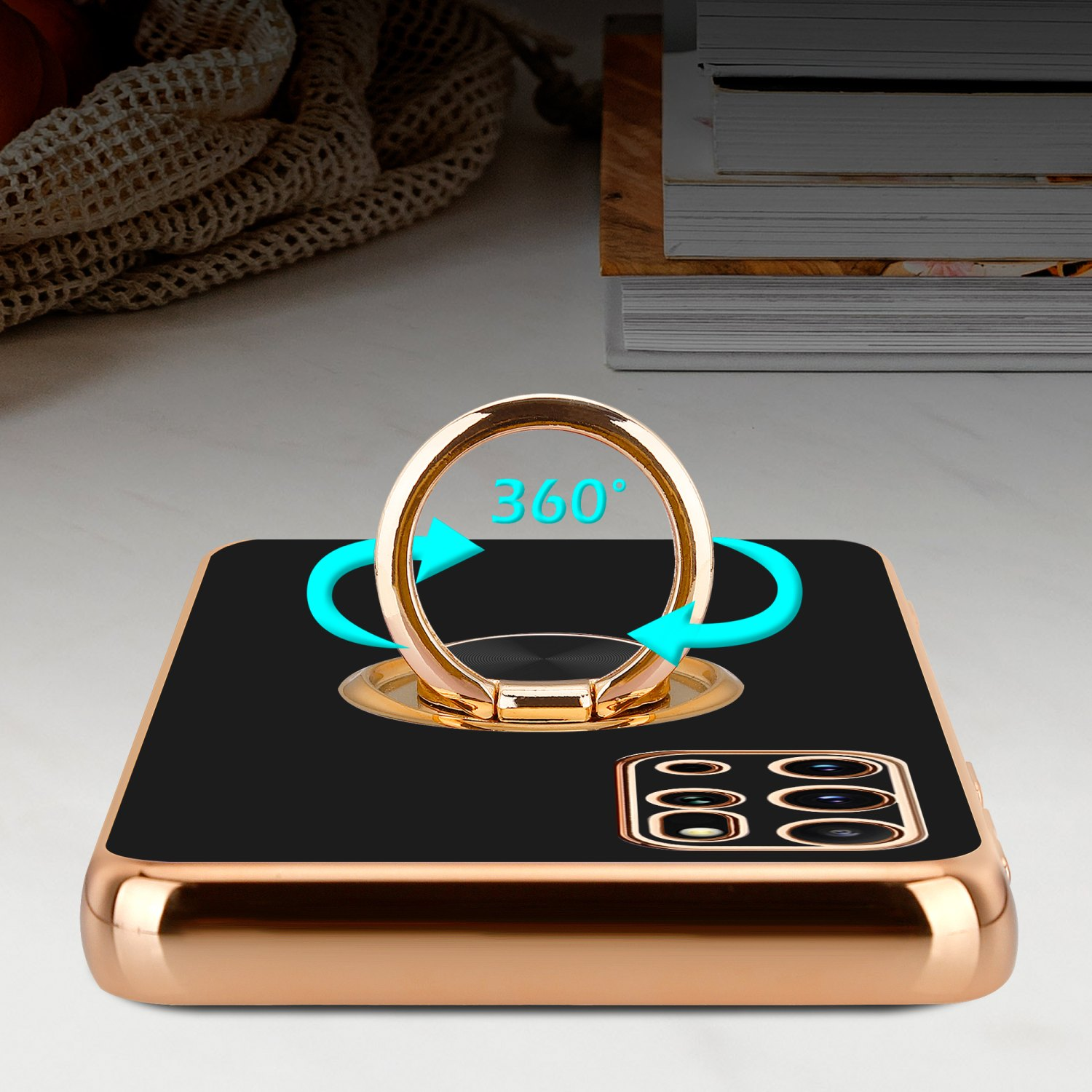 Una custodia nera per telefono con un supporto ad anello dorato. L'anello ruota di 360 gradi.