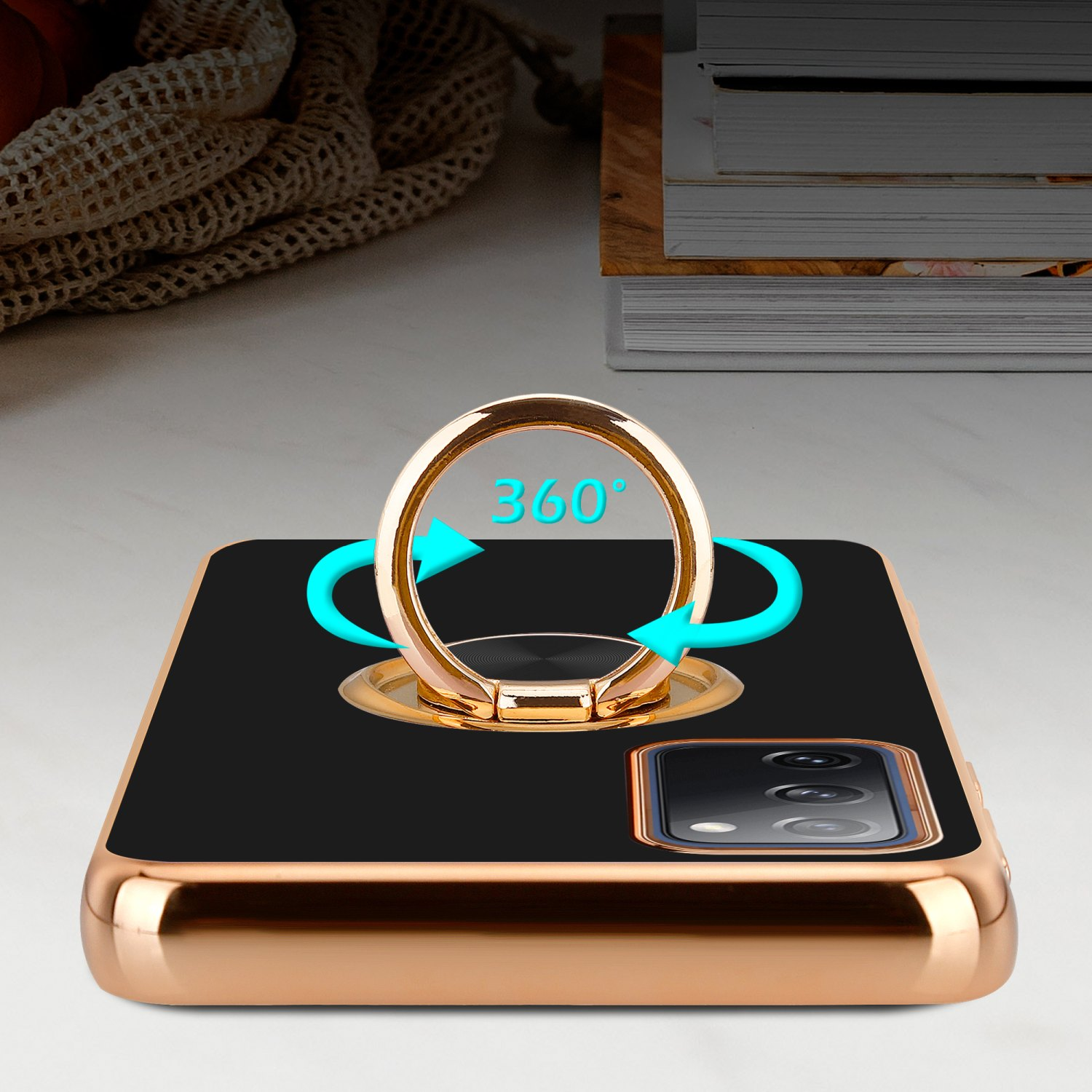 Eine goldene Handyhülle mit schwarzer Rückseite hat einen 360-Ringhalter. Blaue Pfeile sind um den Ring herum abgebildet.