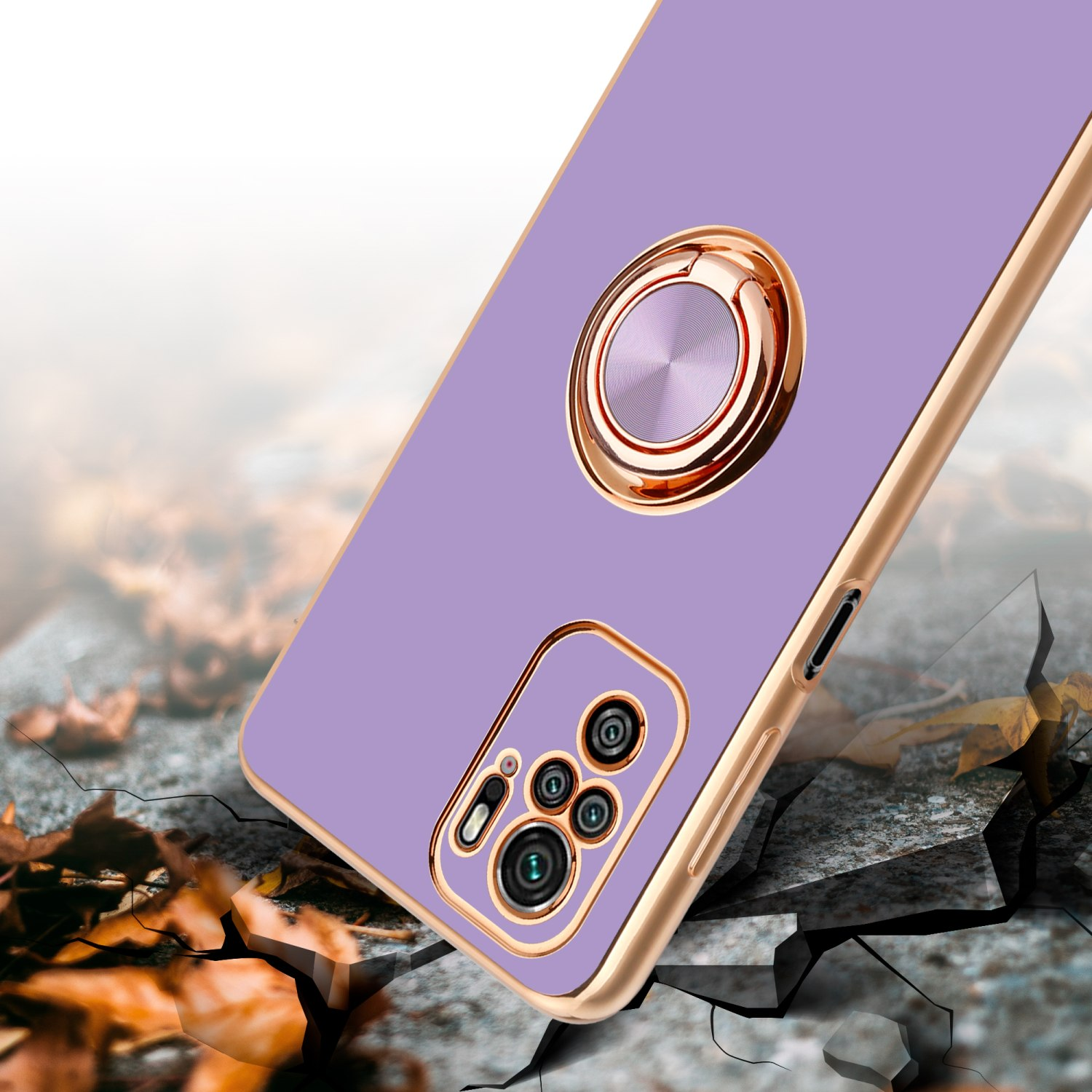 Custodia per telefono viola con supporto ad anello dorato, che impatta su una superficie incrinata, con foglie autunnali.