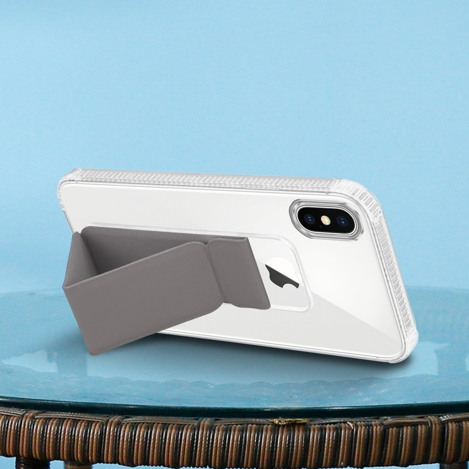 Ein weißes Telefon mit Ständer. Grauer Ständer mit Handyhülle auf blauem Hintergrund.