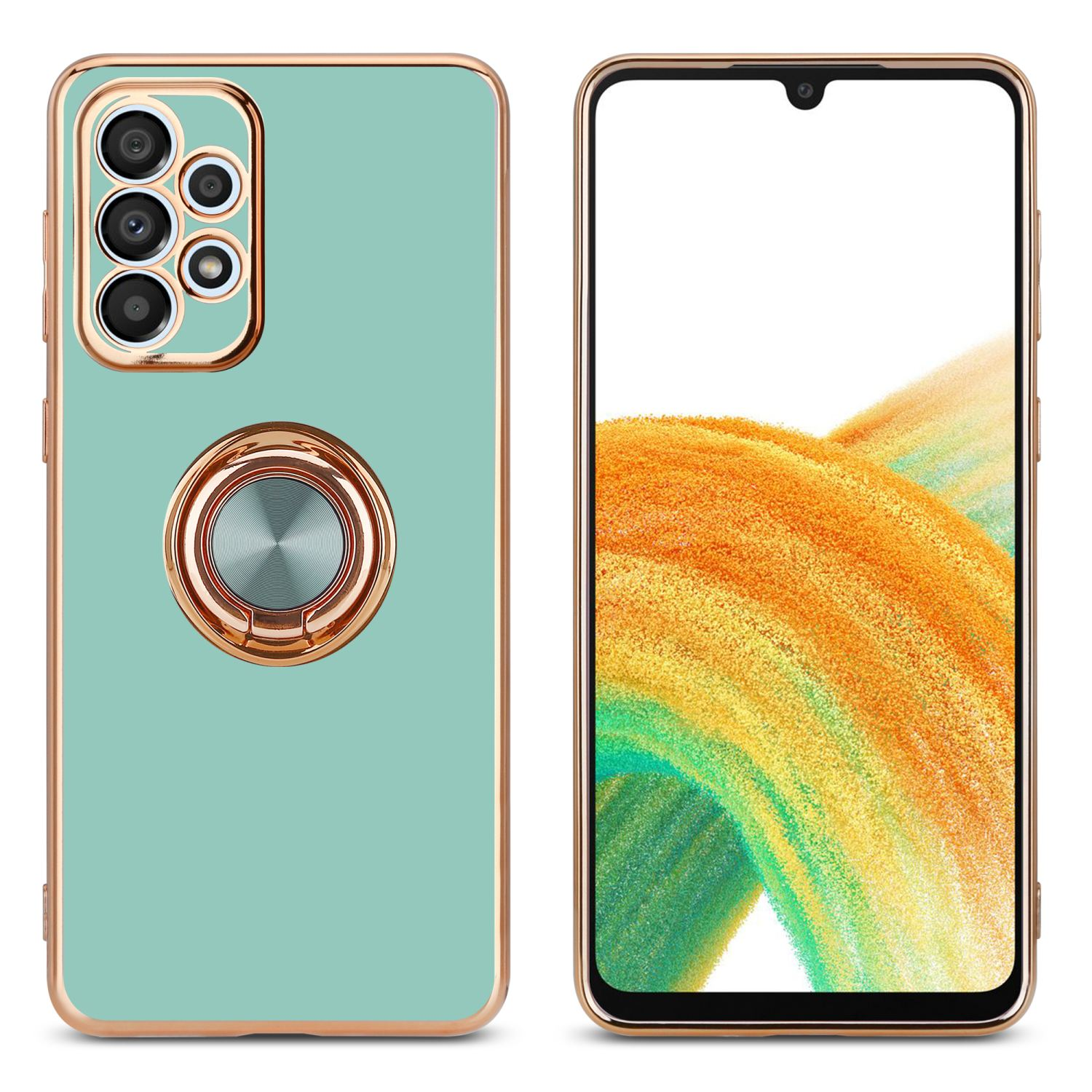 Custodia per telefono con il telefono. Il telefono e la custodia sono verde menta con cornice dorata e porta anello.