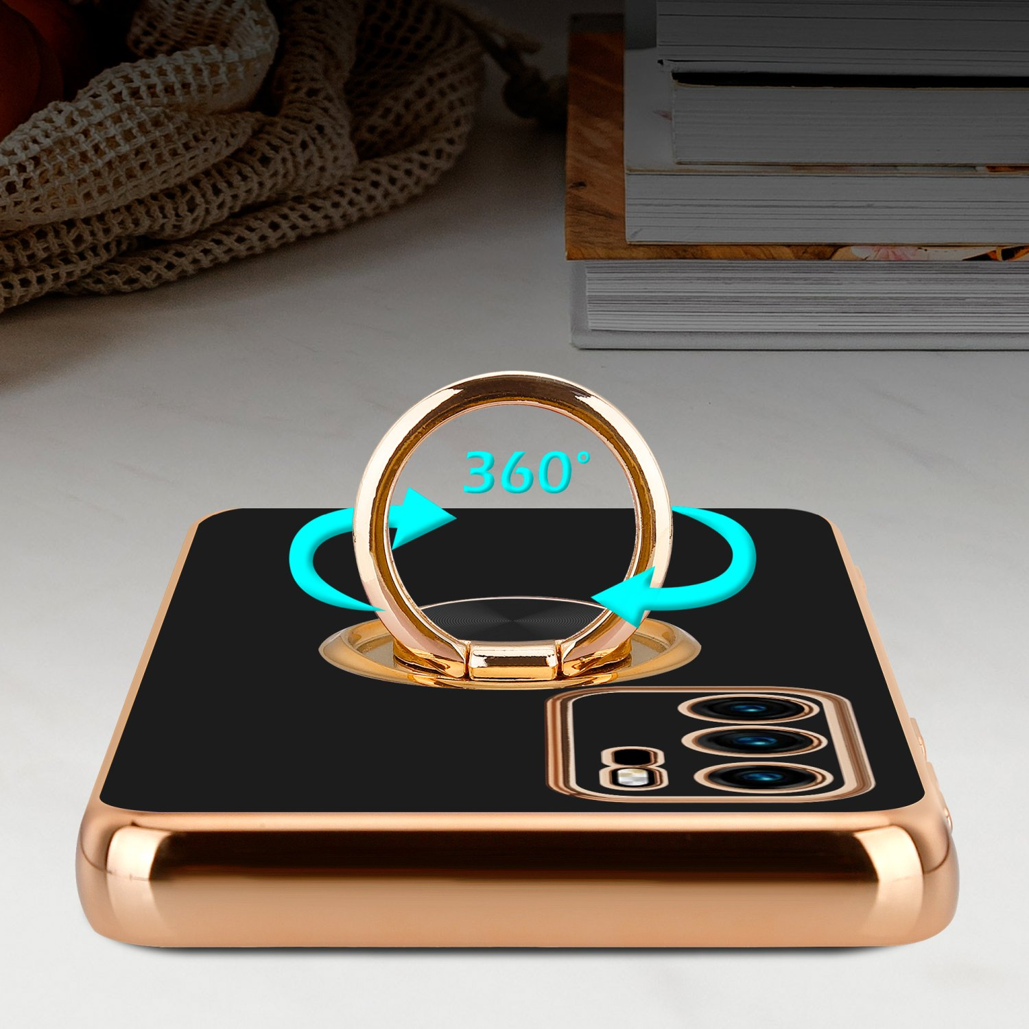 Goldene Handyhülle mit Ringhalter. Pfeile um den Ring, auf einem Tisch.