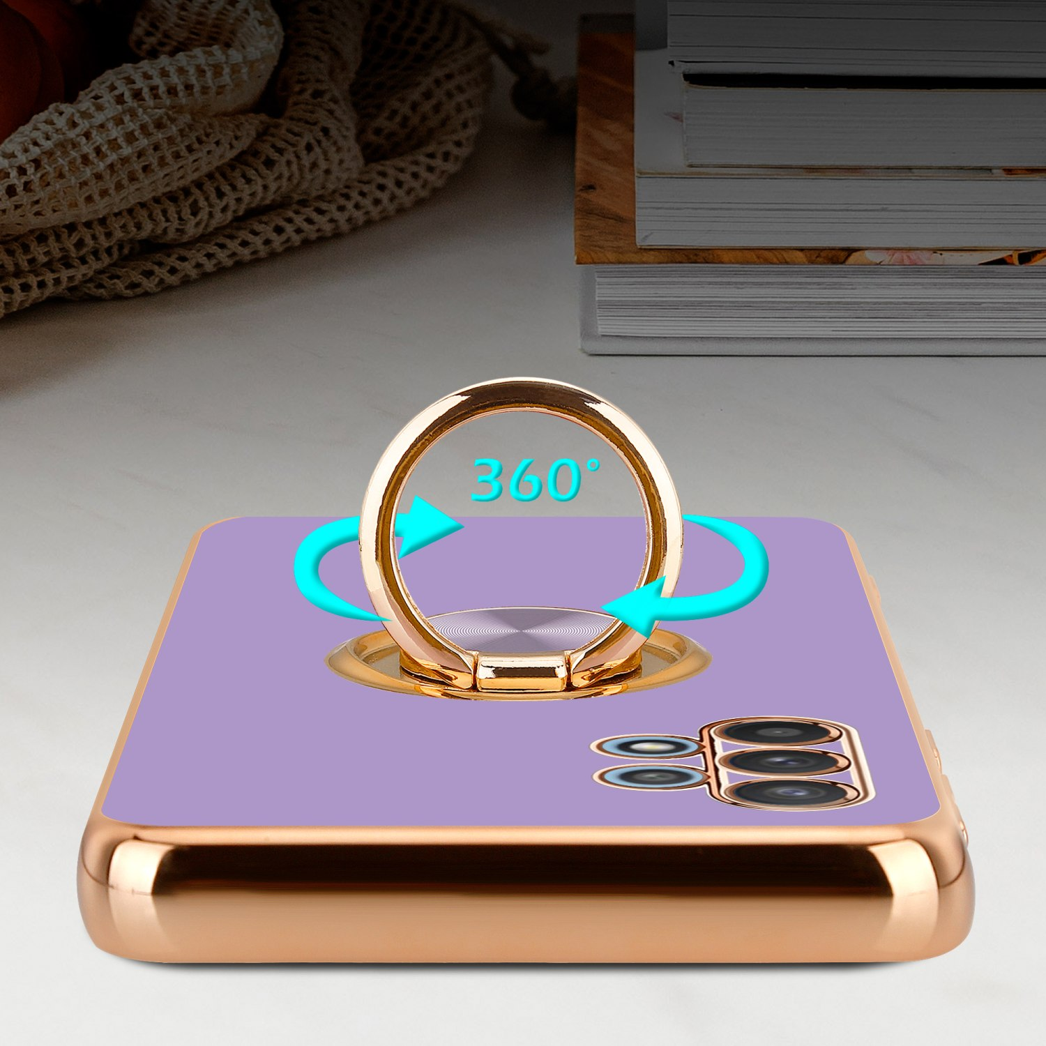 Una custodia per telefono con anello 360 e un telefono. La custodia e il telefono sono viola, con bordo dorato.