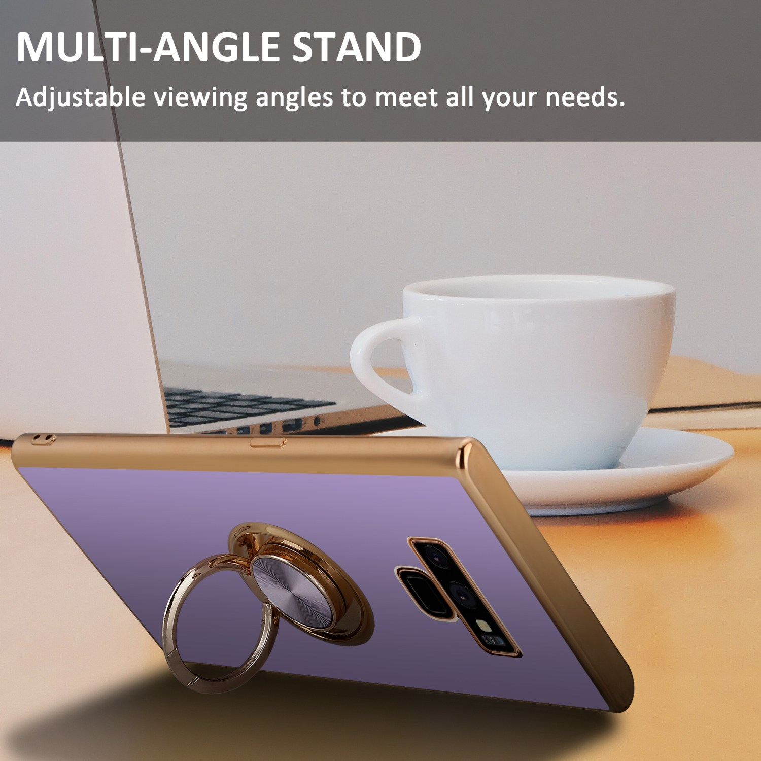 Telefono in custodia dorata con supporto ad anello, su superficie in legno. Tazza bianca e laptop.