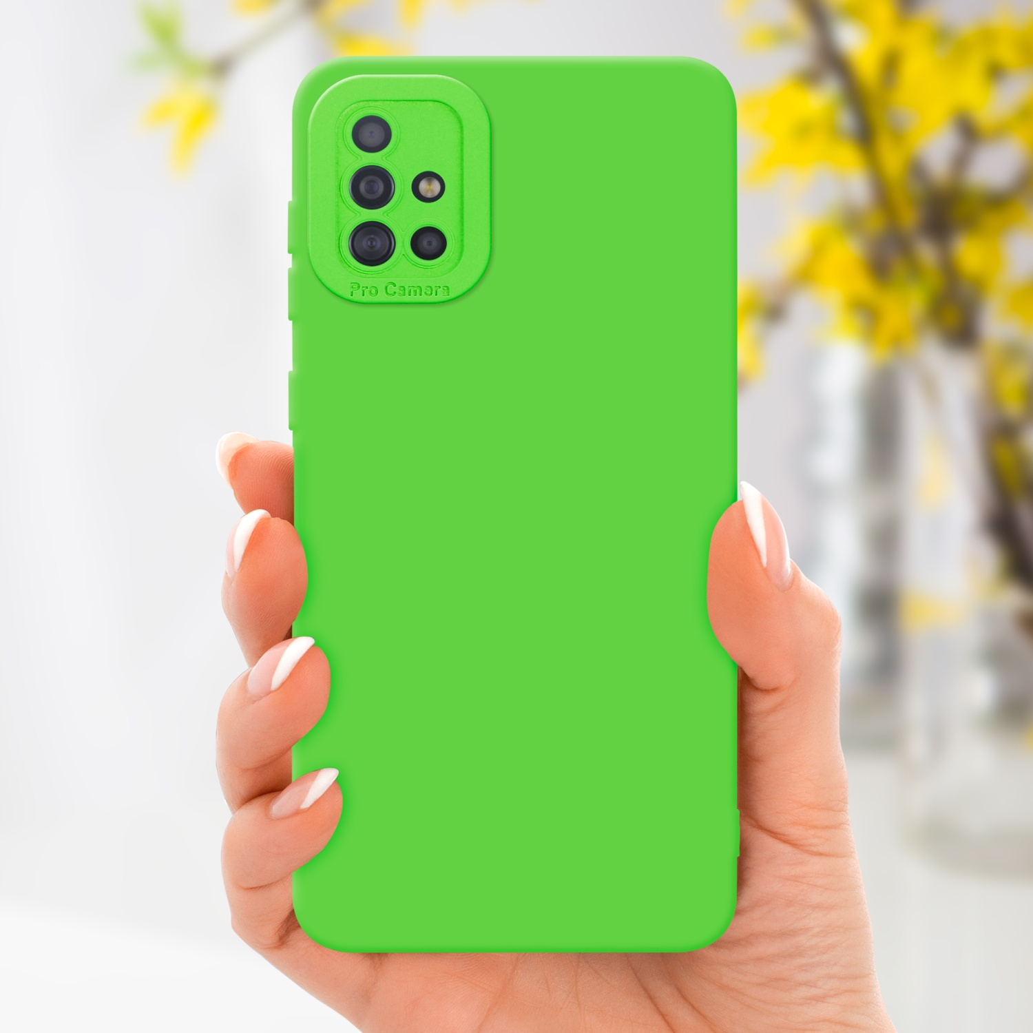 Un étui de téléphone vert tenu par une main. L'étui a une bosse pour l'appareil photo. L'arrière-plan est jaune.