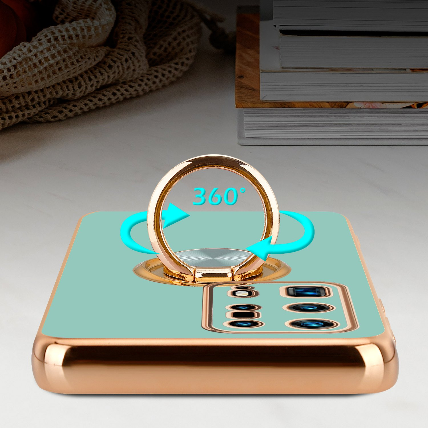 Telefonhülle mit Ringhalter, Gold und Aqua. 360-Grad-Drehung wird mit Pfeilen angezeigt.