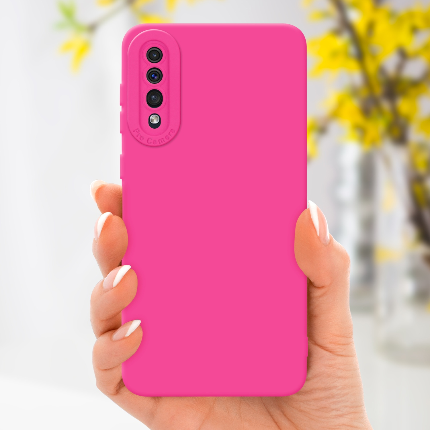 Hand hält pinke Handyhülle mit Kamera auf verschwommenem gelben Hintergrund.