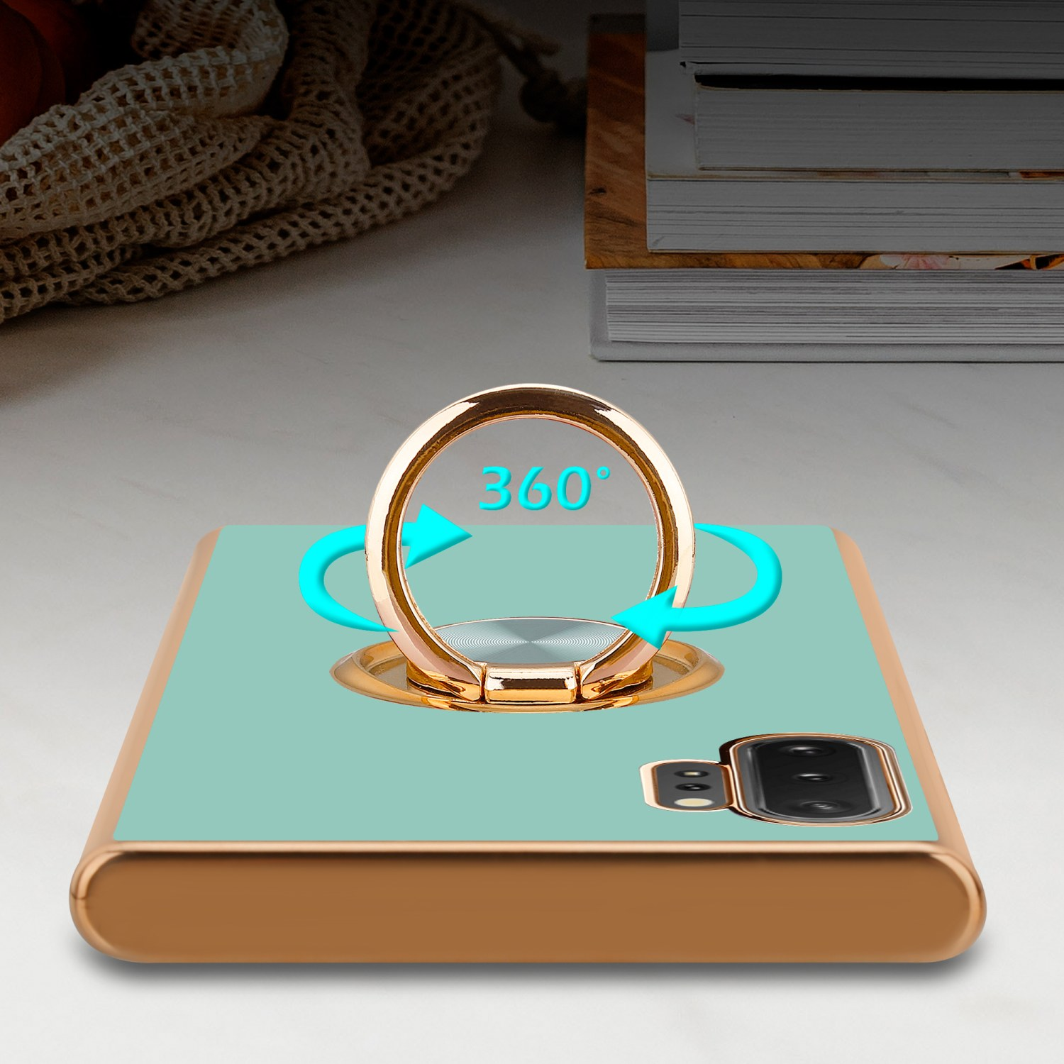 Eine Handyhülle mit Ringhalter, mit Pfeilen, die eine 360-Grad-Drehung anzeigen. Der Hintergrund ist ein Tisch.