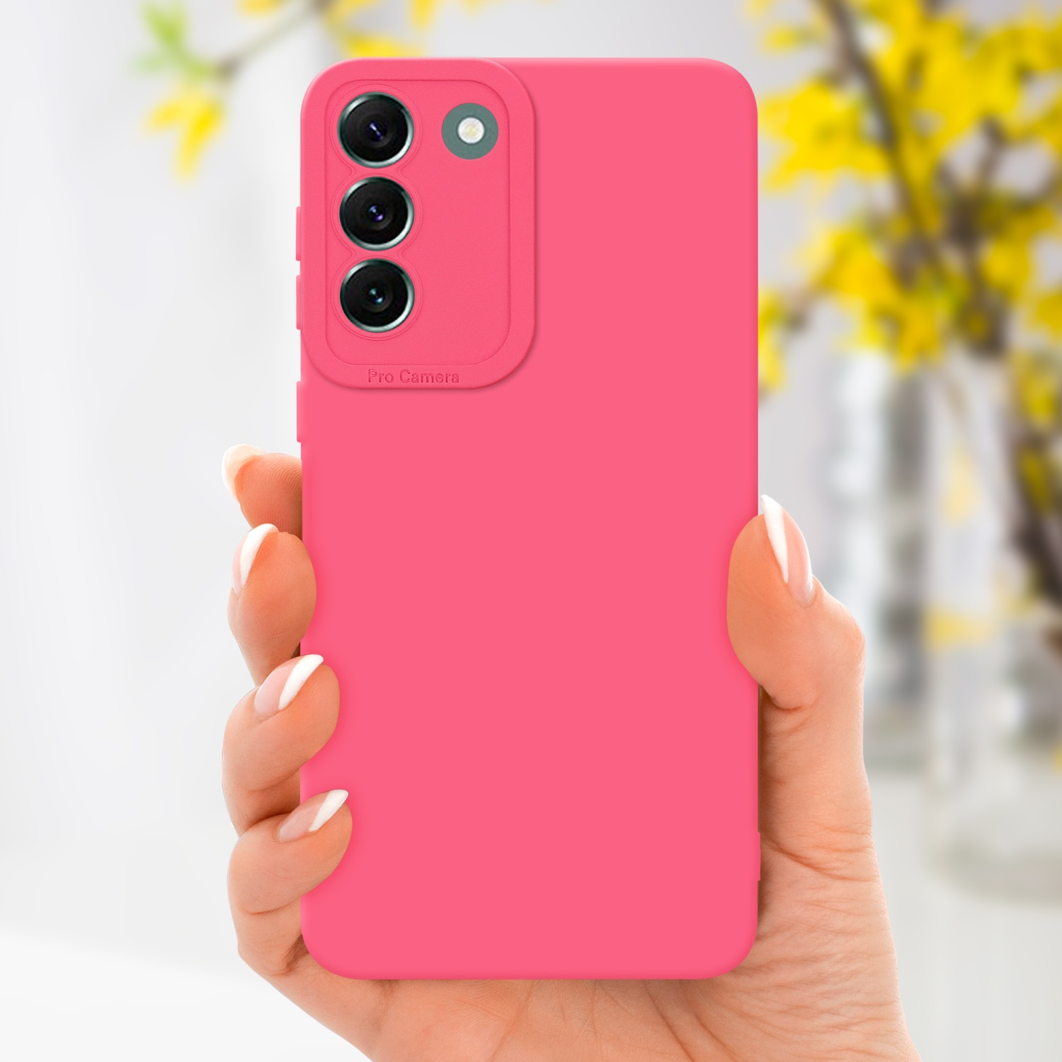 Mano che tiene una custodia rosa per telefono. Sfondo: fiori gialli sfocati.