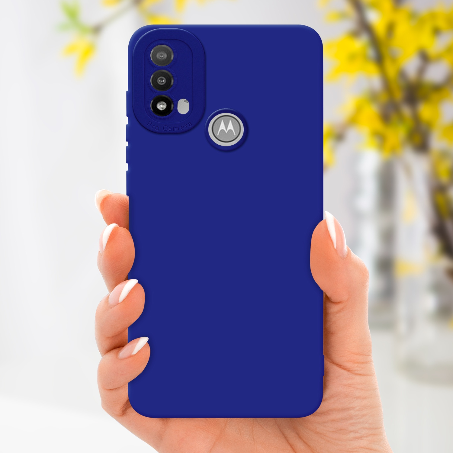 Mano che tiene una custodia blu. Il telefono ha un logo Motorola. Fiori gialli sullo sfondo.