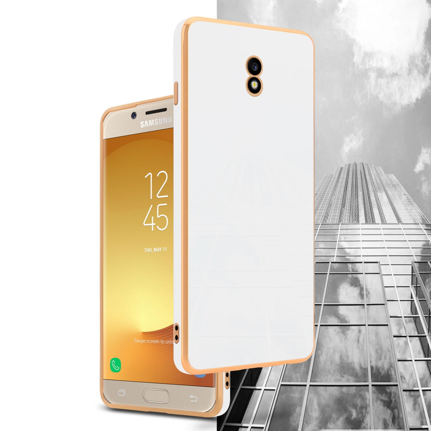 Eine weiße und goldene Handyhülle neben einem Smartphone mit einem Wolkenkratzer im Hintergrund.
