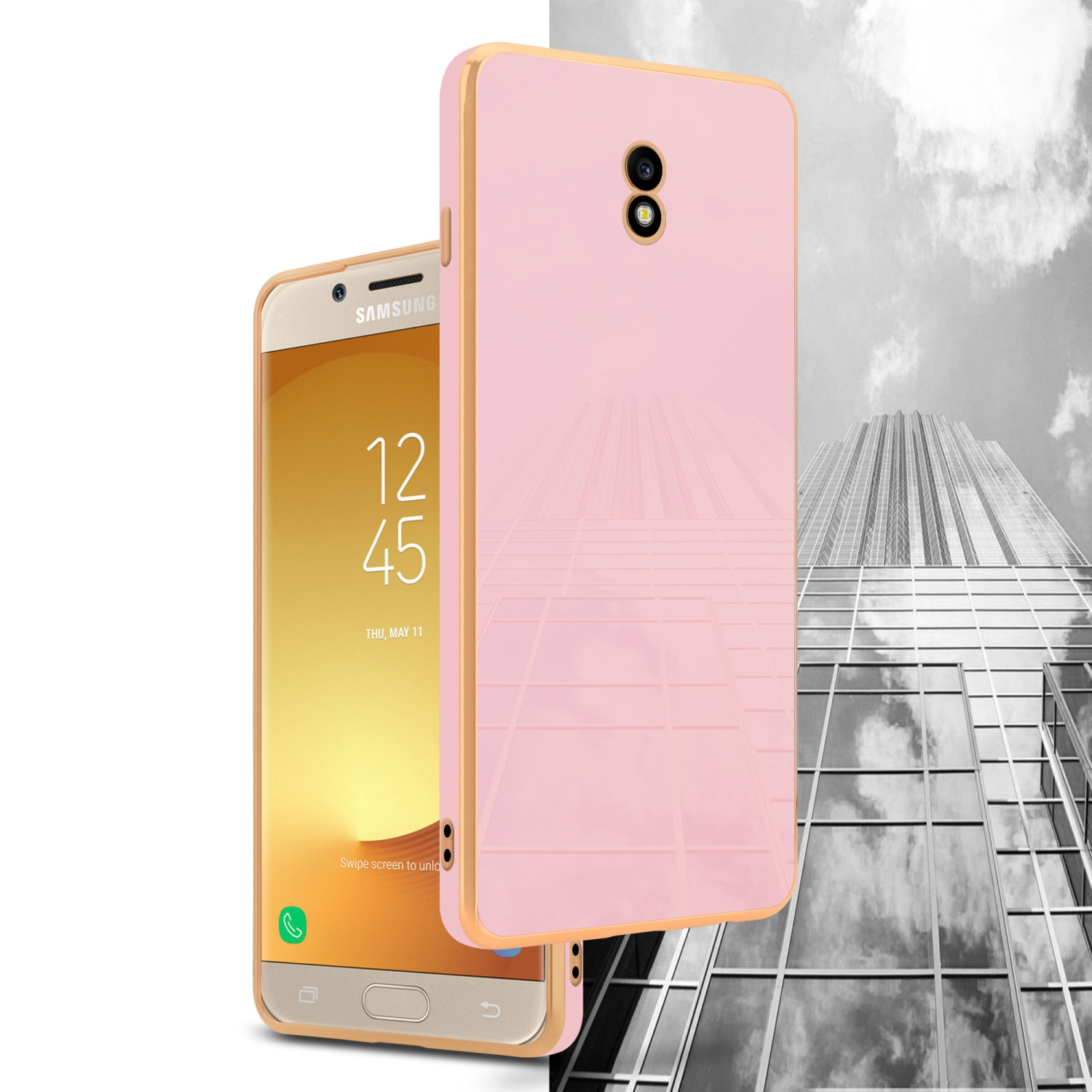 Eine rosa Handyhülle mit goldenem Rand, neben einem Telefon.