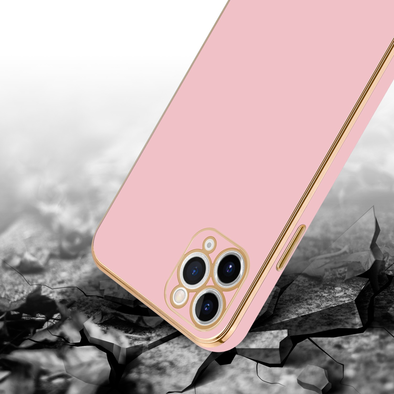 Eine rosa Handyhülle mit goldenem Rahmen, rissige Oberfläche im Hintergrund.