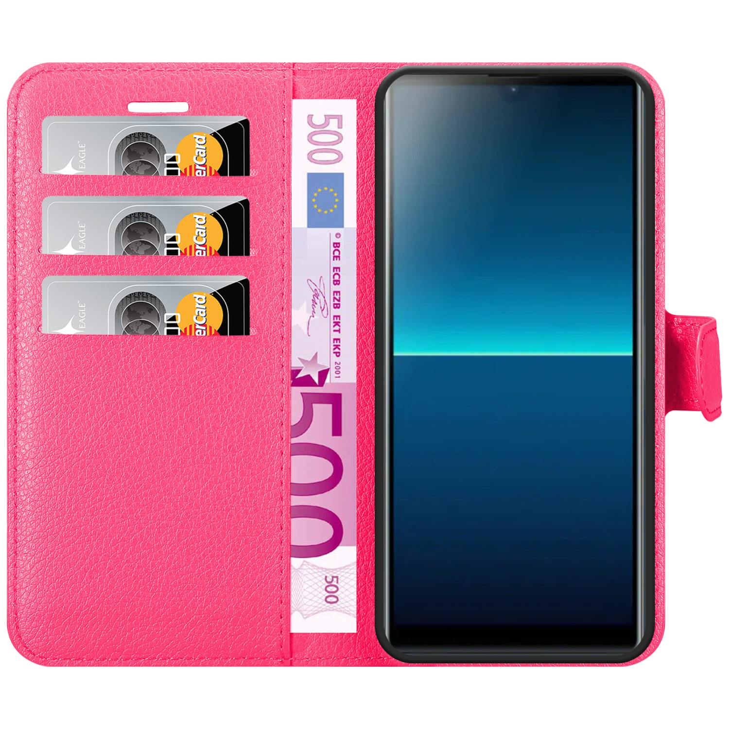 Custodia rosa per telefono con denaro e carte.