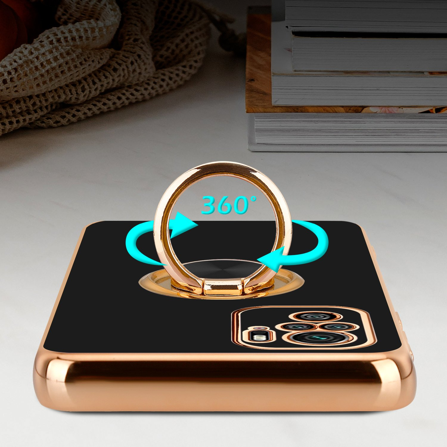 Una custodia per telefono oro e nera con un porta anello. L'anello mostra 360 gradi.