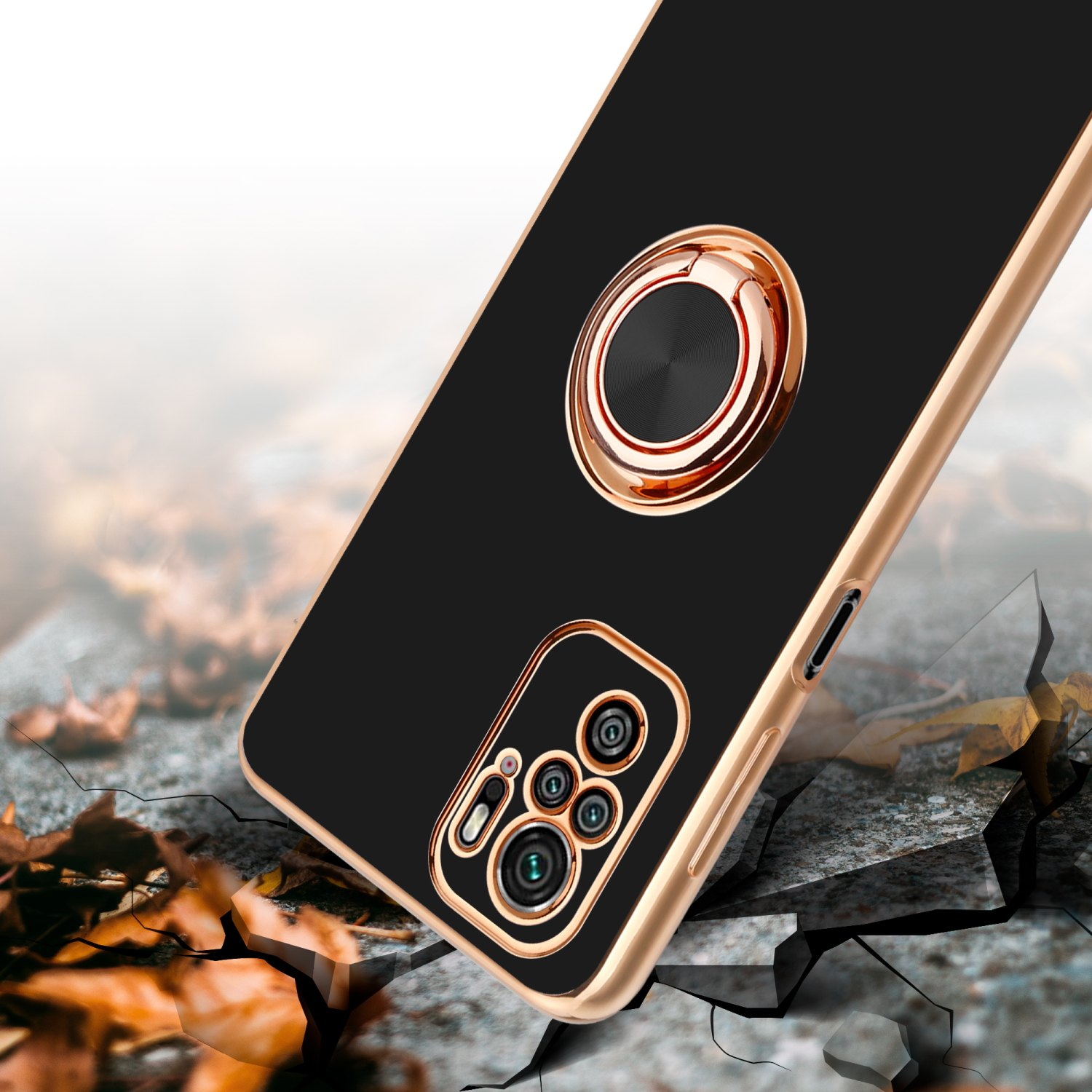 Custodia per telefono nera e oro con supporto ad anello su terreno crepato.