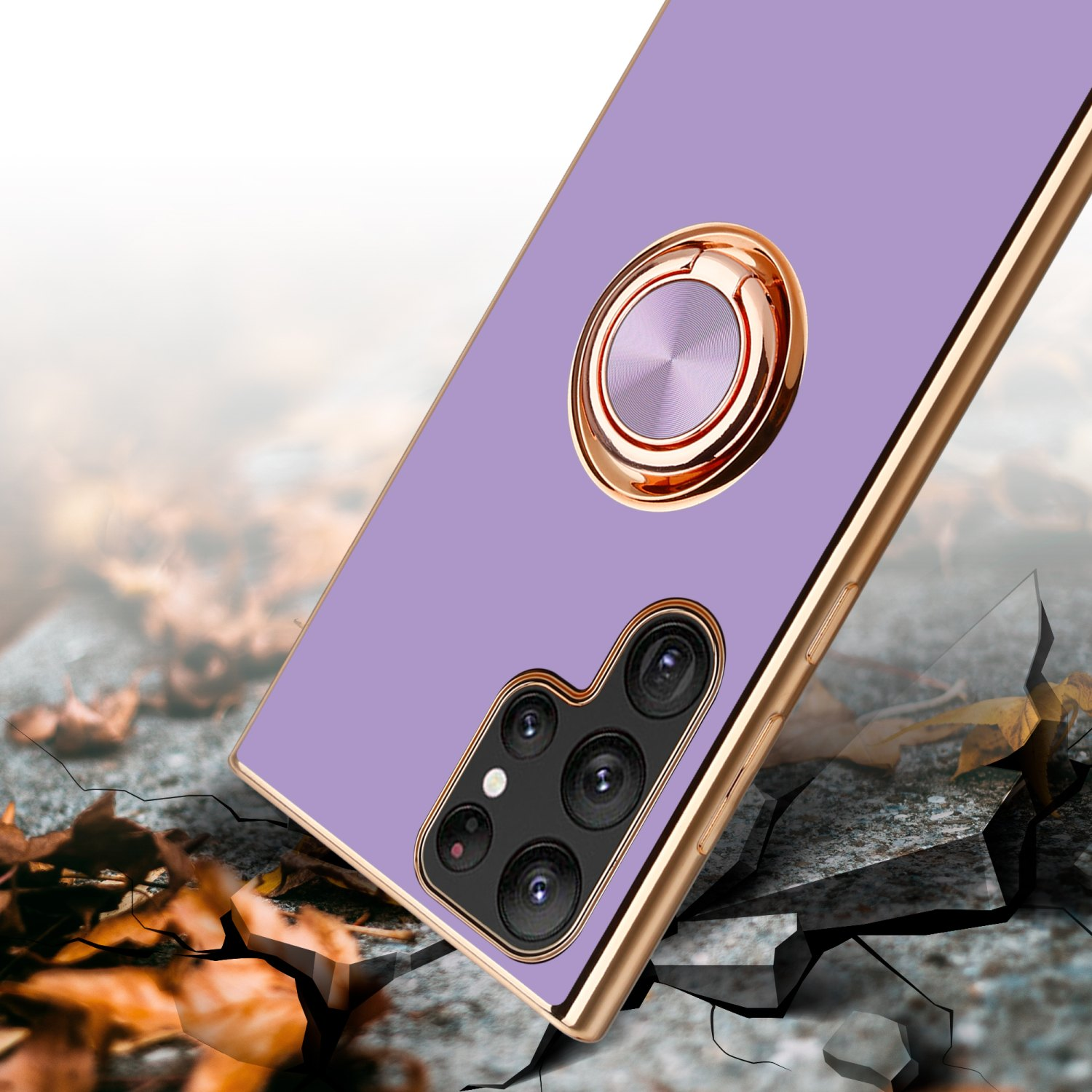 Telefono viola con supporto ad anello dorato, in diagonale su superficie incrinata.