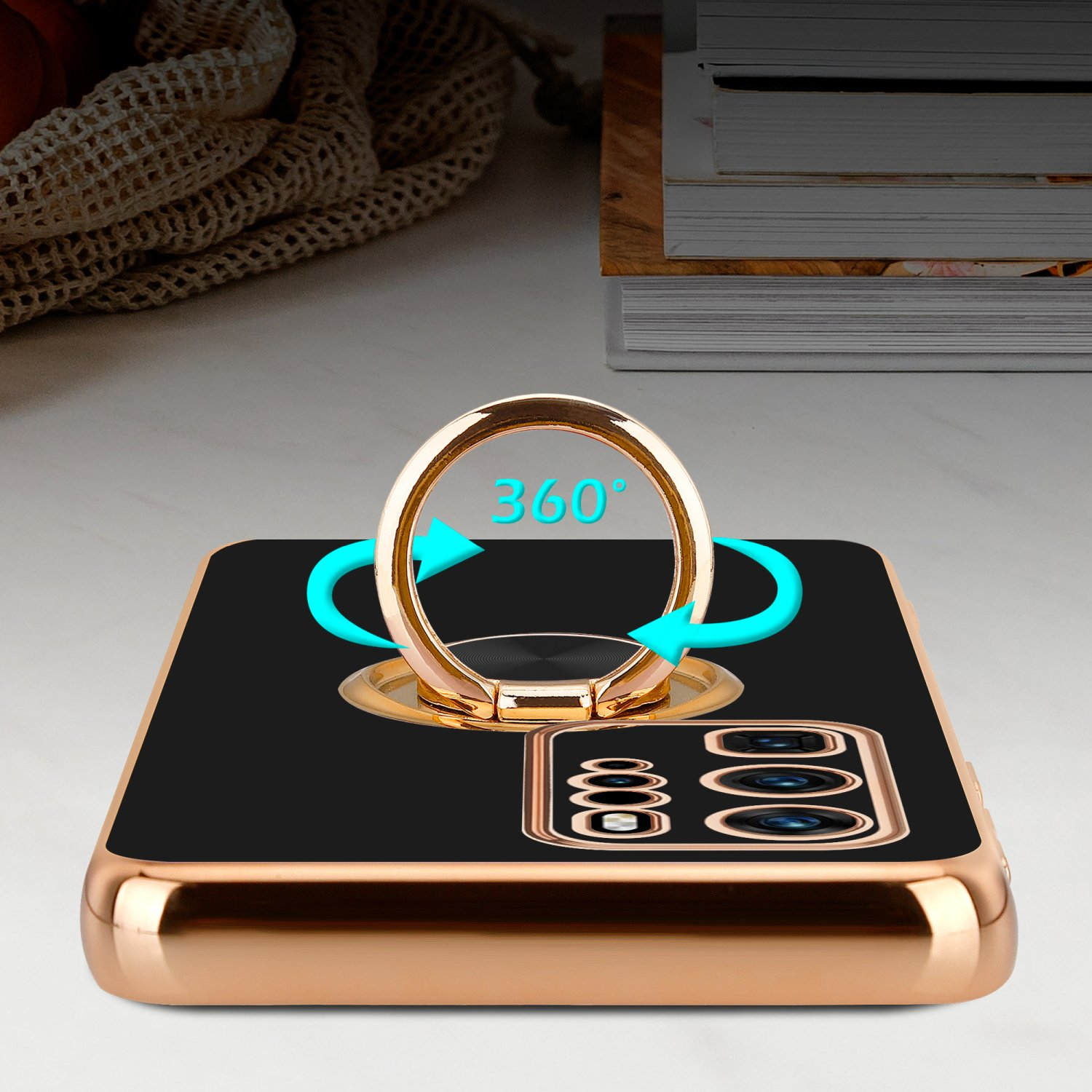 Eine schwarze Handyhülle mit goldenem Ringhalter. Blaue Pfeile zeigen eine 360°-Drehung an.