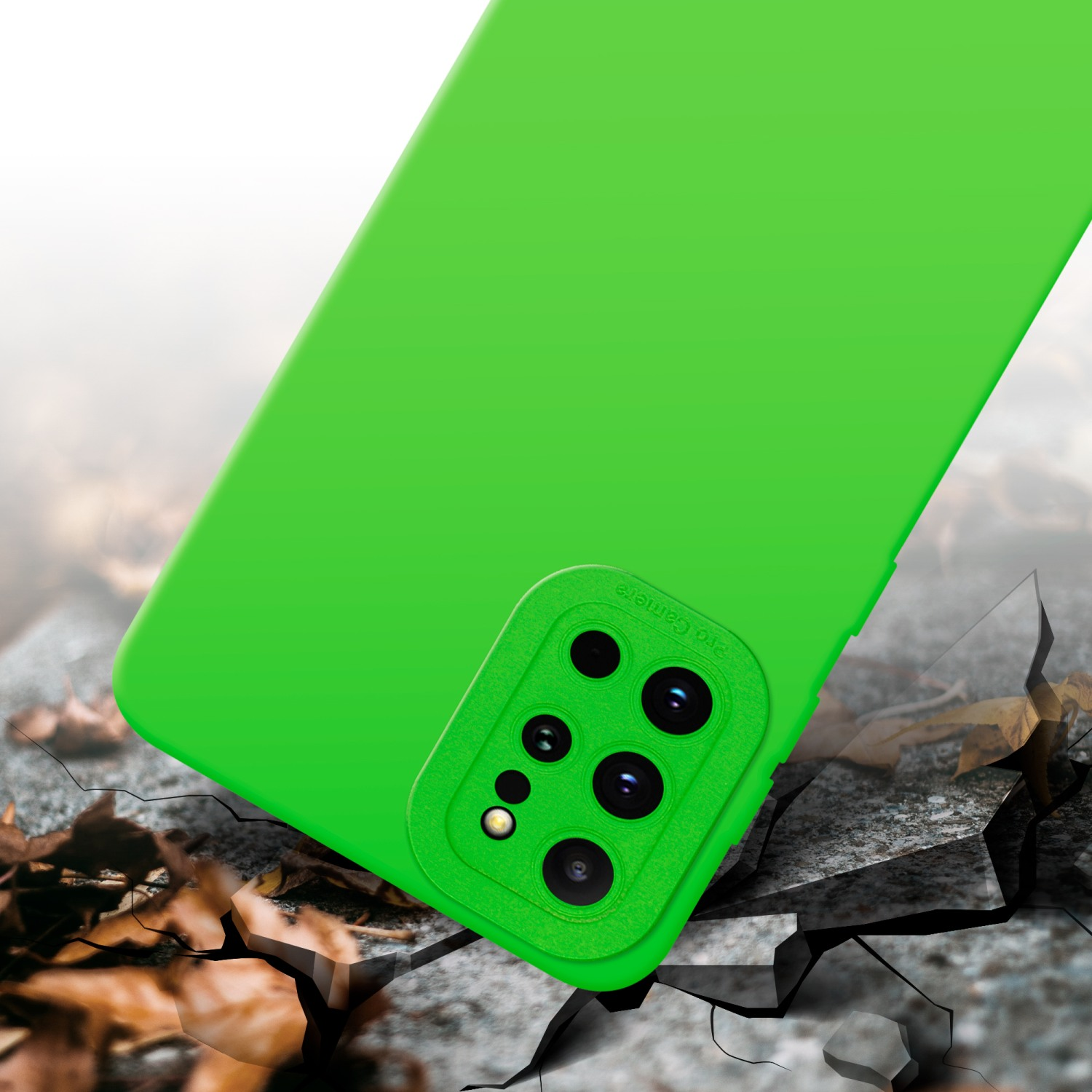 Custodia per telefono verde con intaglio per fotocamera. Lo sfondo mostra cemento crepato e foglie.