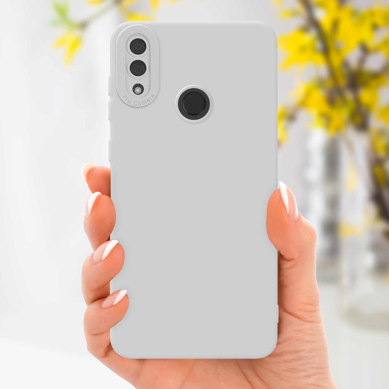 Main tenant une coque de téléphone gris clair, montrant l'arrière du téléphone avec une découpe caméra.