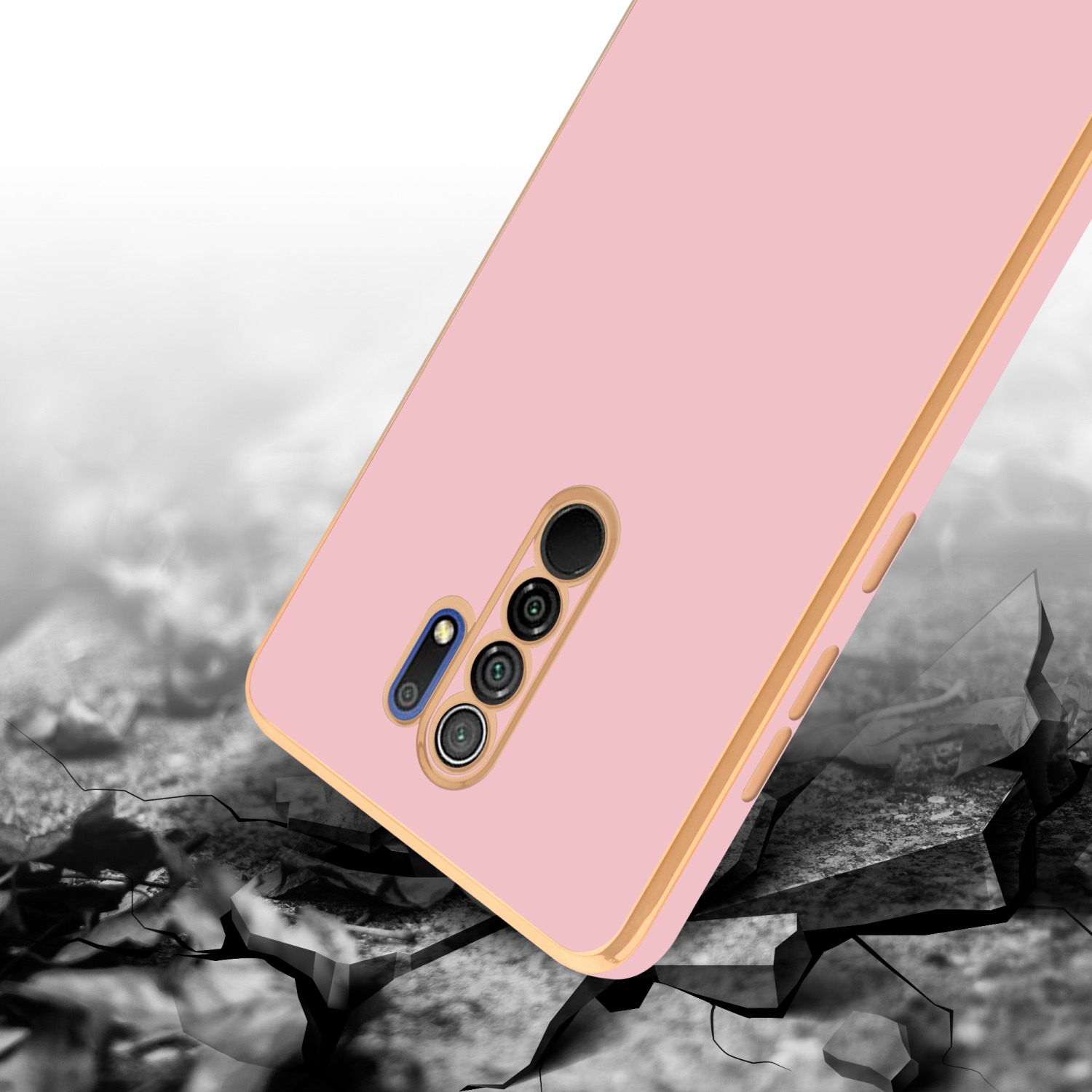 Rosa Handyhülle mit Goldkanten liegt auf rissiger Oberfläche. Das Telefon hat Kameraaussparungen.