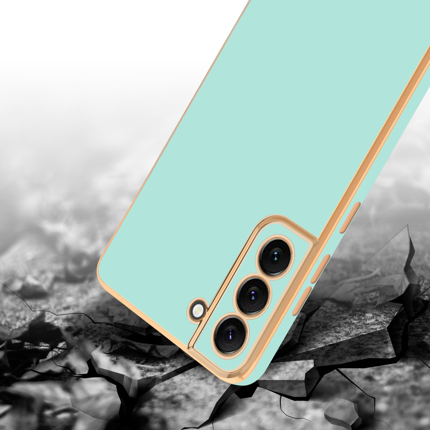 Eine mintgrüne Handyhülle mit goldenem Rahmen. Das Telefon wird durch Aufprall beschädigt.
