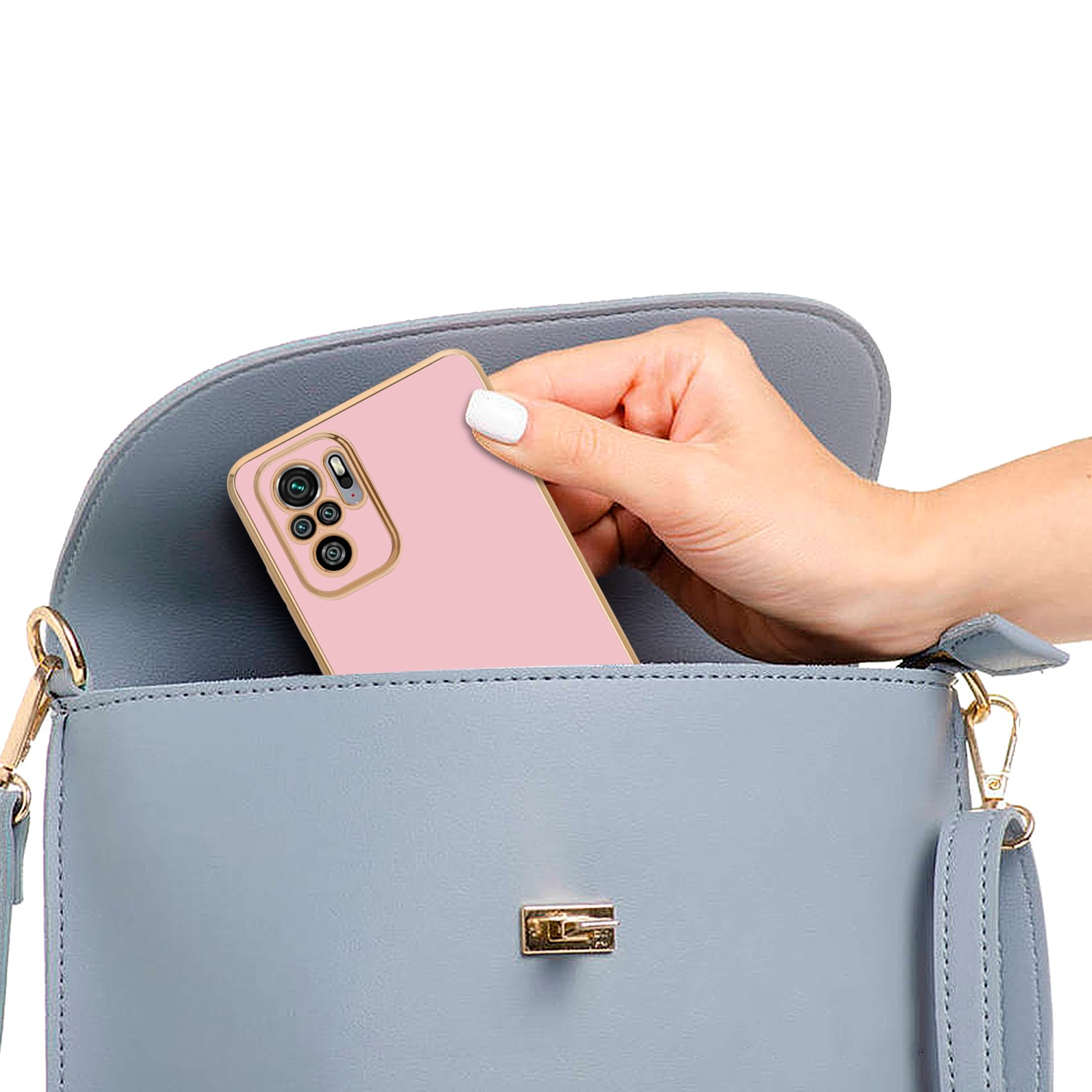 Mano che tiene una custodia per telefono rosa, dentro una borsa blu.