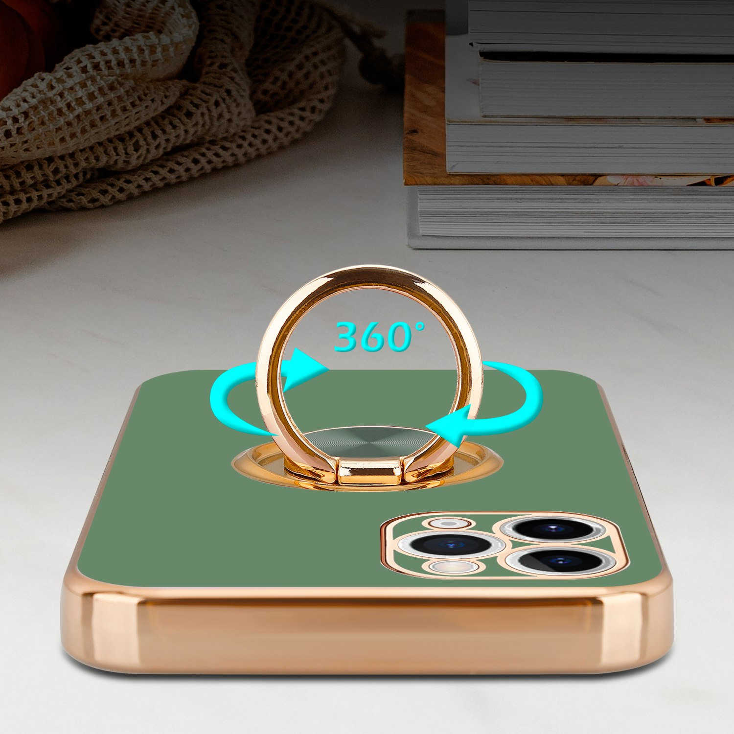 Grünes Telefon mit goldenem Ringhalter, der Ring ist 360 Grad. Goldener Telefonkörper auf weißem Untergrund.