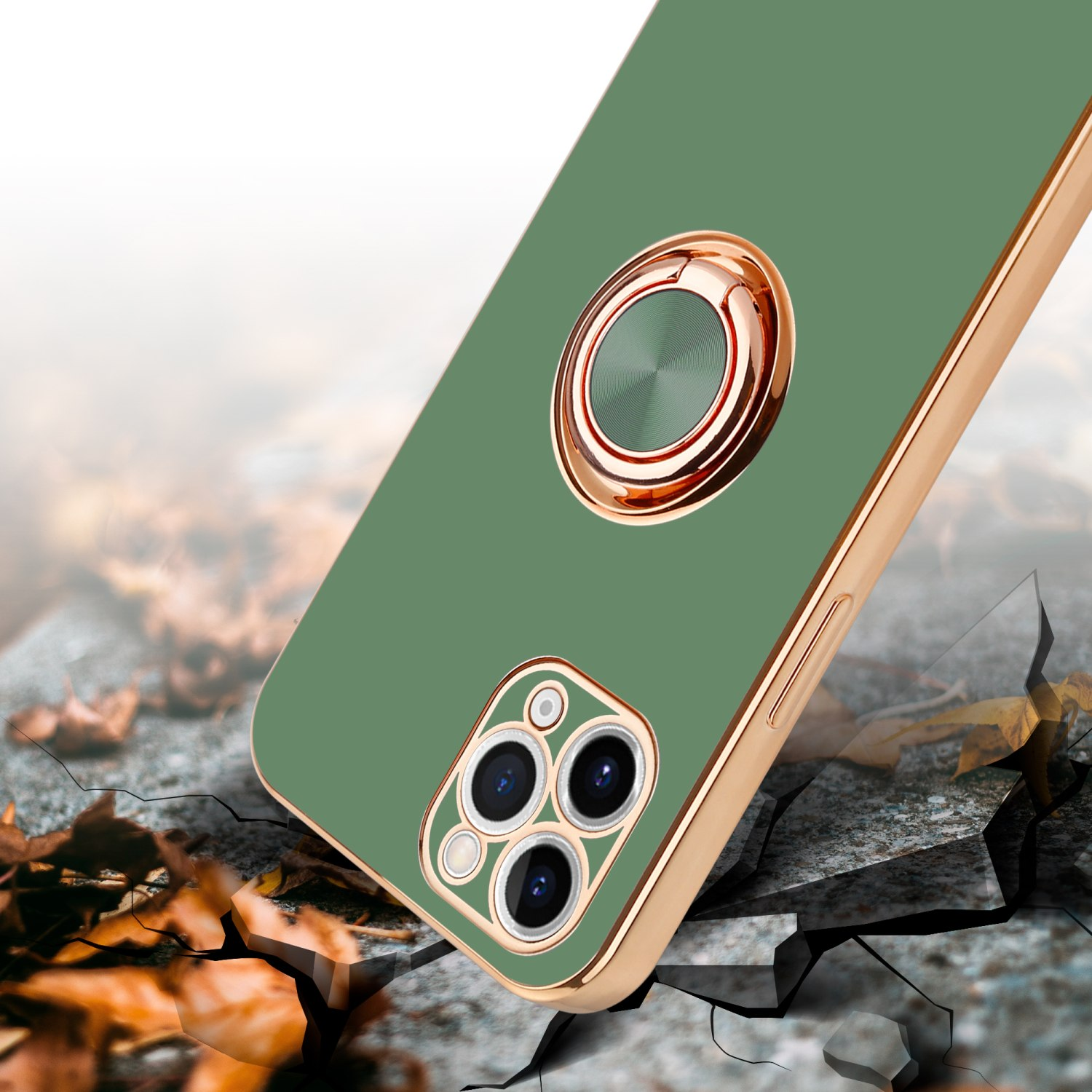 Grüne Handyhülle mit goldenem Ringständer und Telefon auf rissiger Oberfläche.