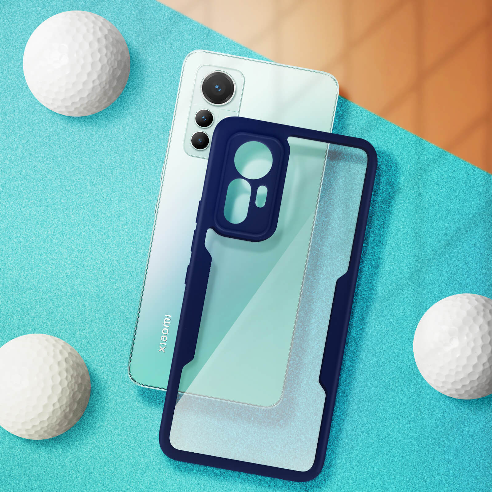 Un téléphone avec un étui et des balles de golf sur une surface bleue.