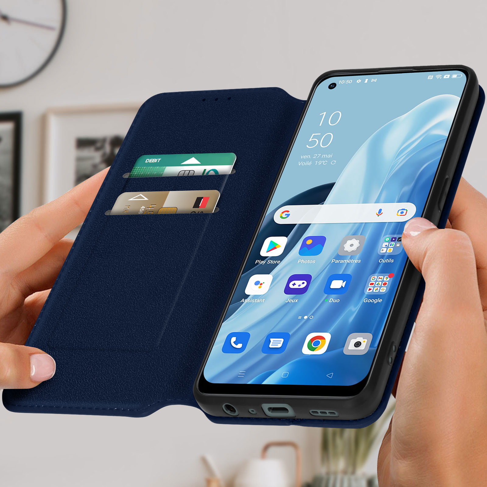 Una persona che tiene un telefono in una custodia a portafoglio blu, mostrando uno schermo con app e carte.