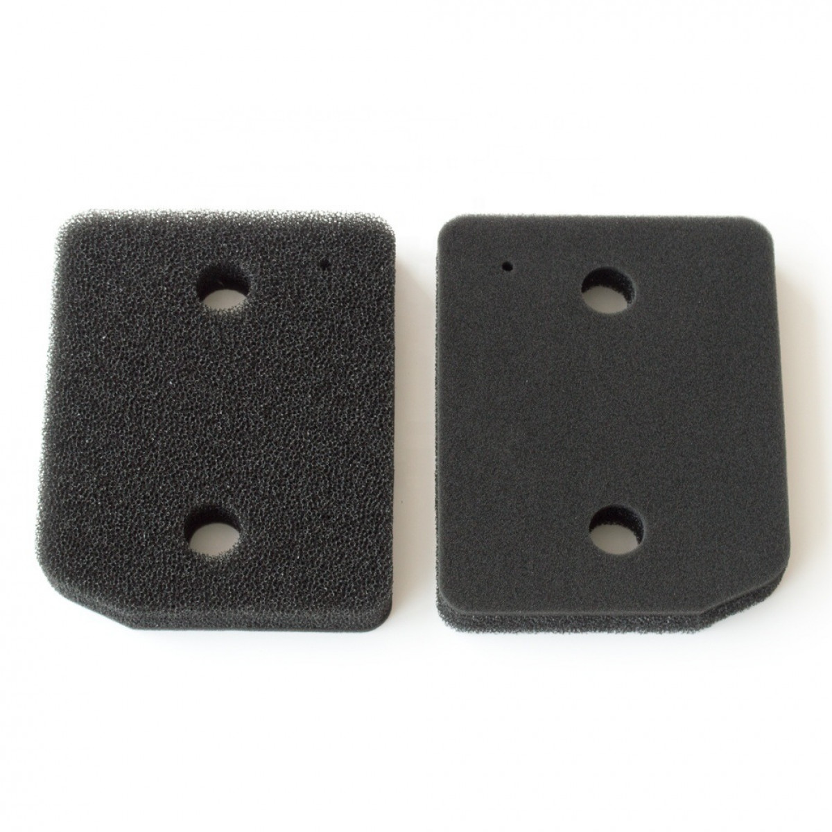 Dwa czarne kawałki filtra powietrza z otworami, na białym tle.