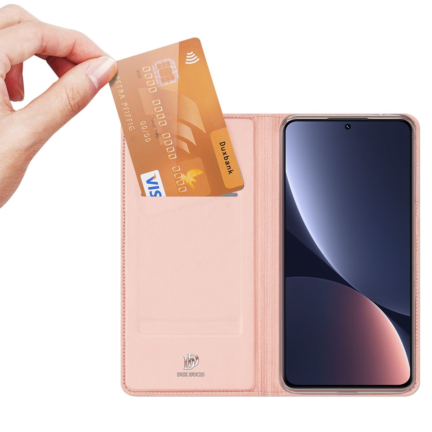Una mano inserisce una carta di credito in una custodia rosa con un telefono all'interno.