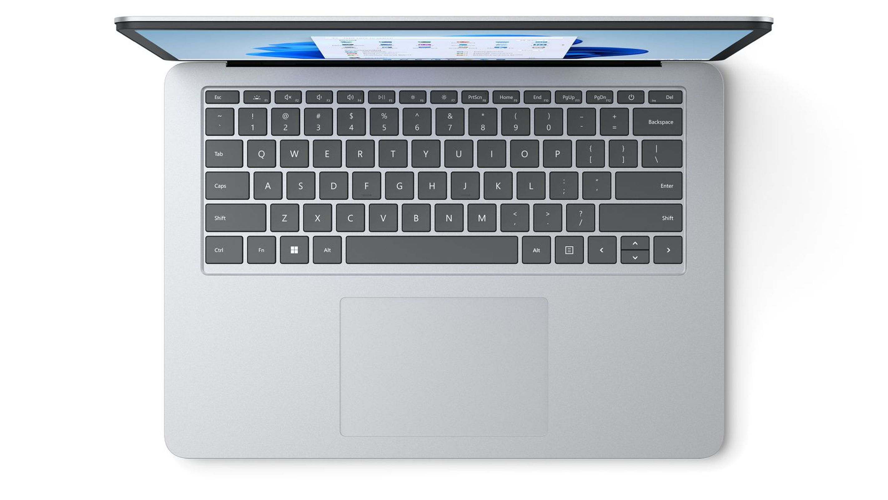 Laptop dall'alto, color argento, con tastiera, touchpad e sito web sullo schermo.