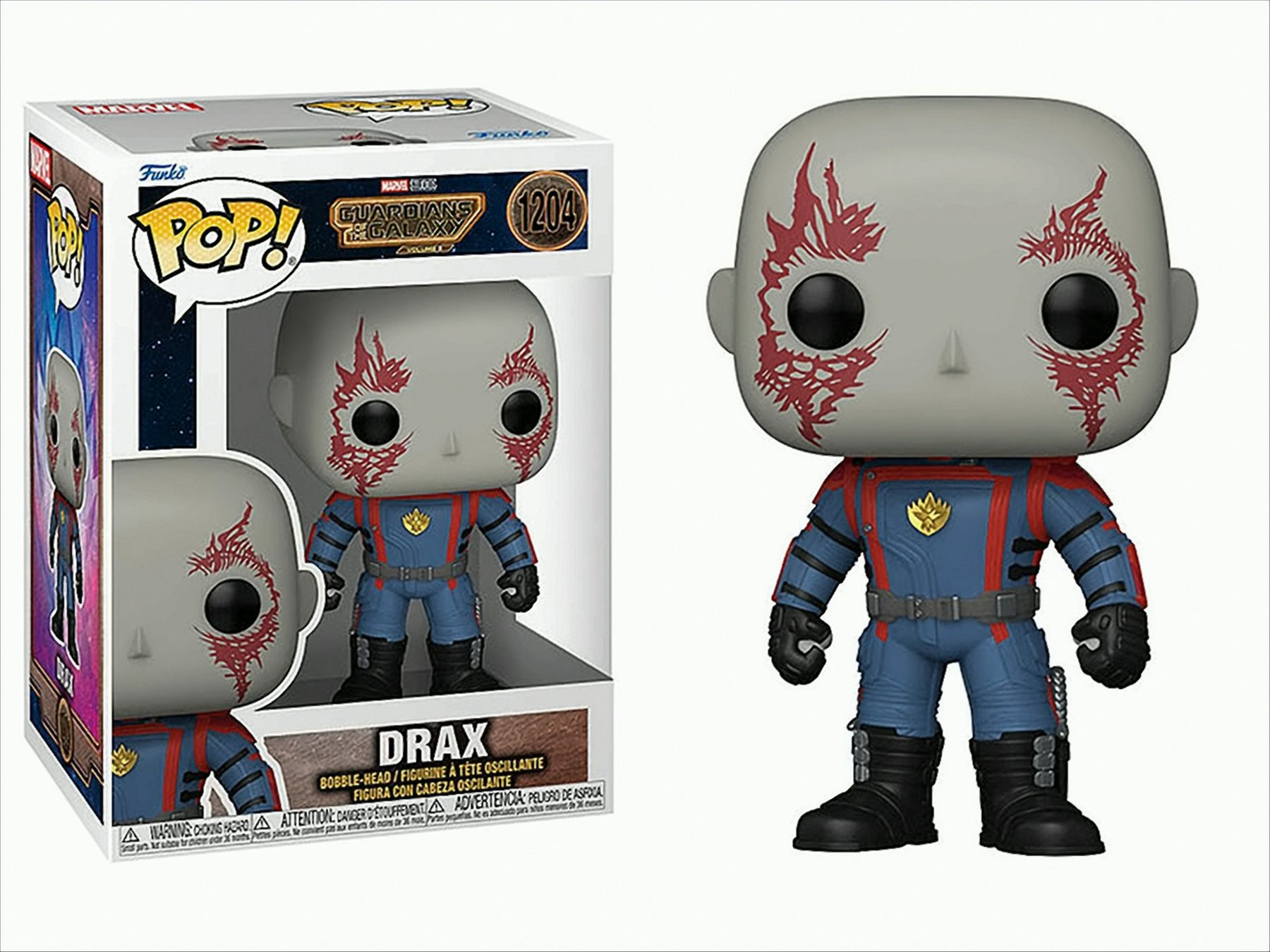 Una figura Funko Pop di Drax e la sua scatola. La figura ha segni rossi sulla pelle grigia, un completo blu e rosso.